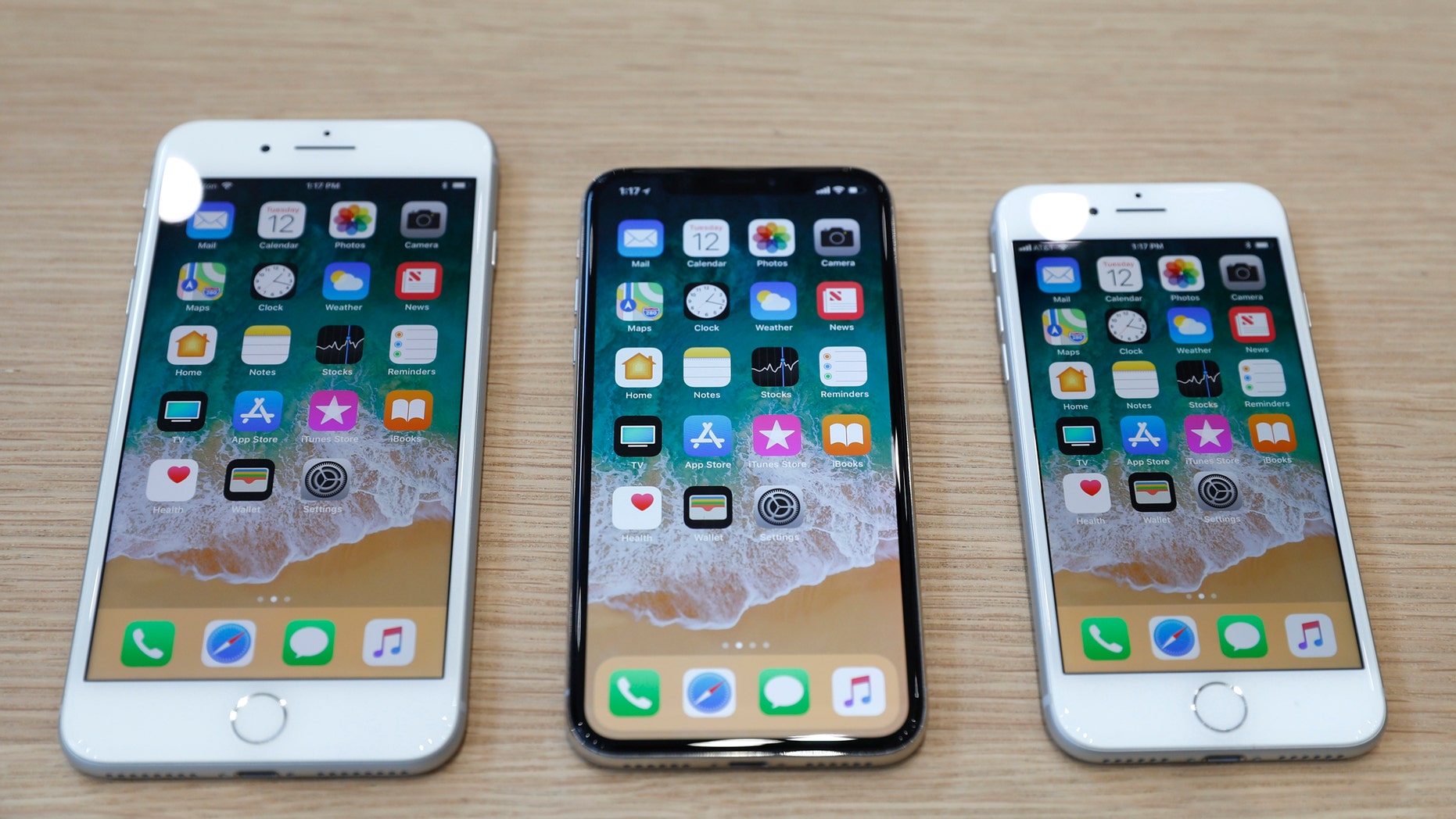 (L-R) iPhone 8 Plus, iPhone X and iPhone 8 models are displayed during an Apple launch event in Cupertino, California, U.S. Sept. 12, 2017. (REUTERS/Stephen Lam)