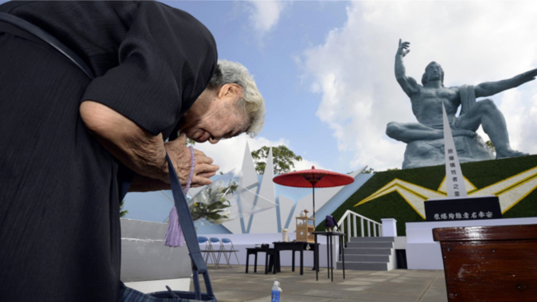 Aug. 9, 2013: A woman offers prayers at Nagasaki Peace Park in Nagasaki, southern Japan to mark the 68th anniversary of the world's second atomic bomb attack over the city.
