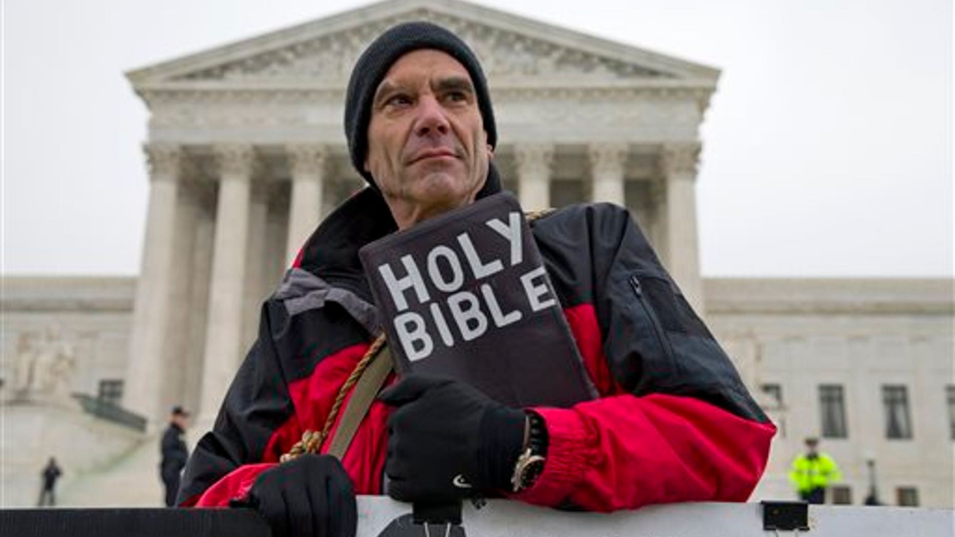 In this Jan. 15, 2014 file photo, Alan Hoyle, of Lincolnton, N.C., stands outside the Supreme Court in Washington, Wednesday, Jan. 15, 2014, where the court heard arguments on a state of Massachusetts law setting a 35-foot (10 meter) protest-free zone outside abortion clinics. (AP Photo/ Evan Vucci, File)