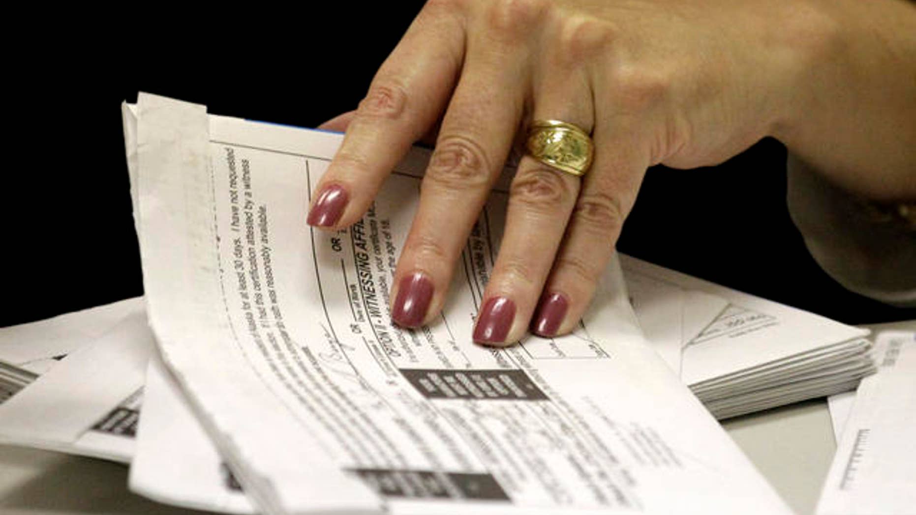 FILE: An undated picture of a U.S. voter filing out an absentee ballot.