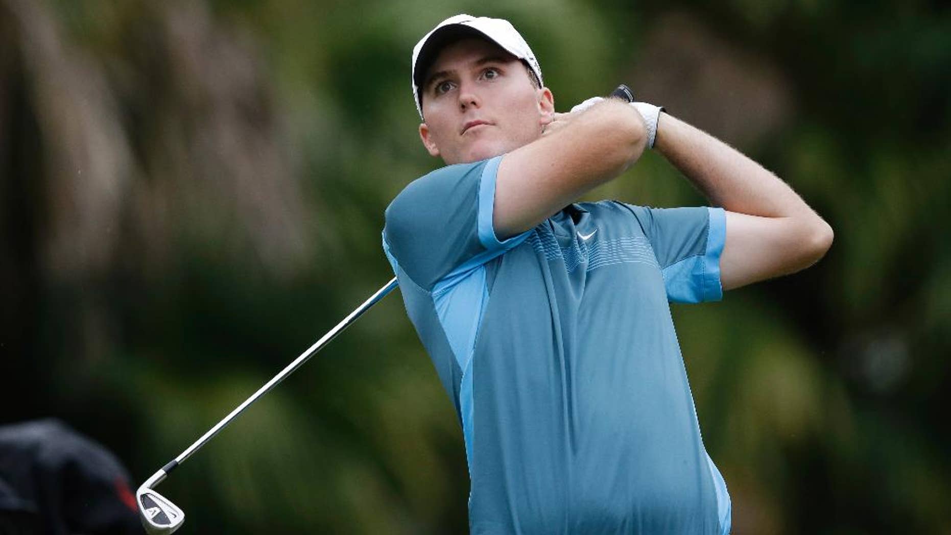 Russell Hunley watches from the 13th tee during the first round of the Cadillac Championship golf tournament Thursday, March 6, 2014, in Doral, Fla. (AP Photo/Wilfredo Lee)