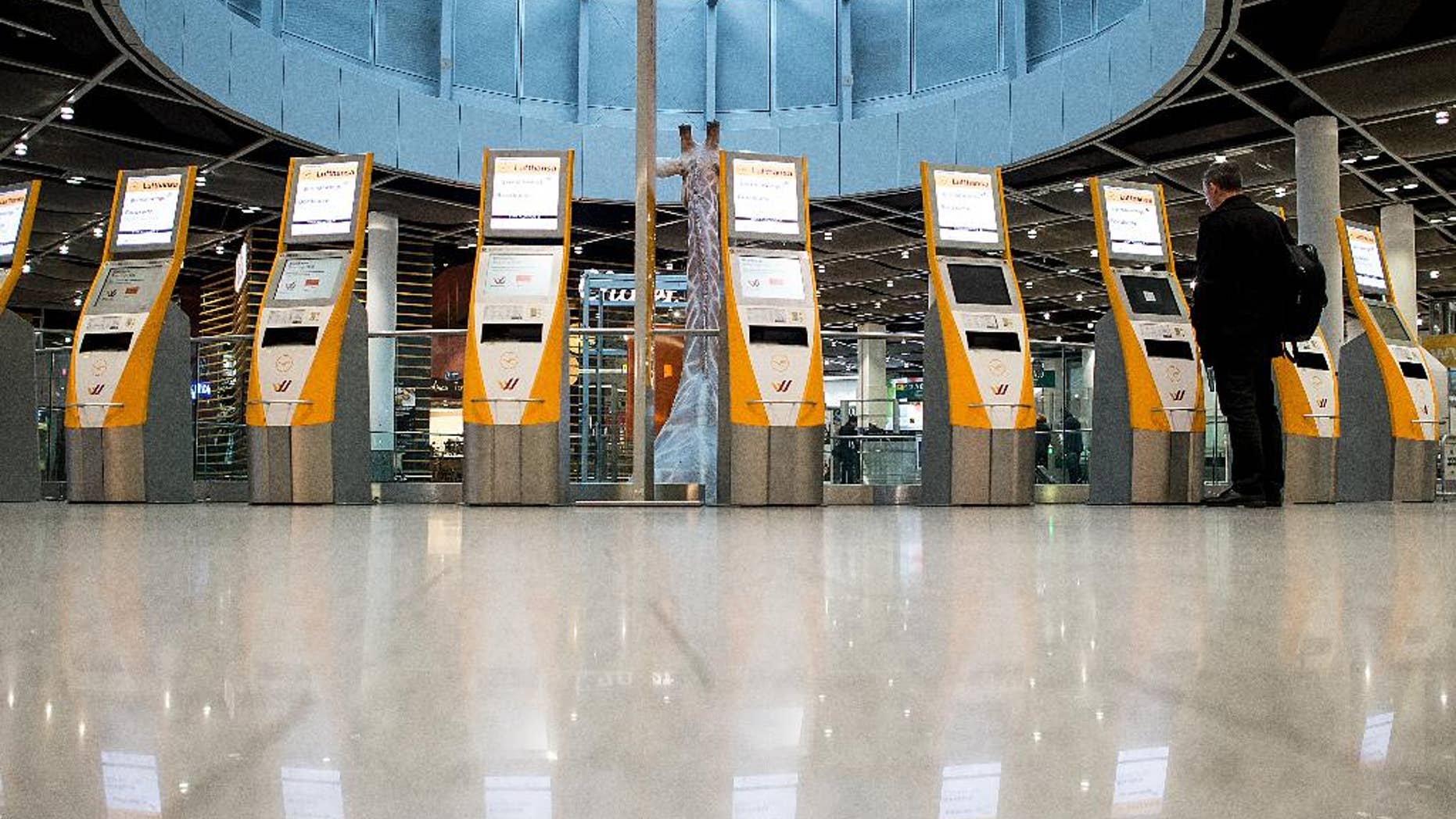 Unused check-in terminals are reflected on the floor in the airport in Duesseldorf, western Germany, Friday morning, March 20, 2015. Lufthansa pilots continue their strike in a dispute centering on the airline's plans to cut transition payments for pilots wanting to retire early, which the union wants to see maintained continues. (AP Photo/dpa, Maja Hitij)