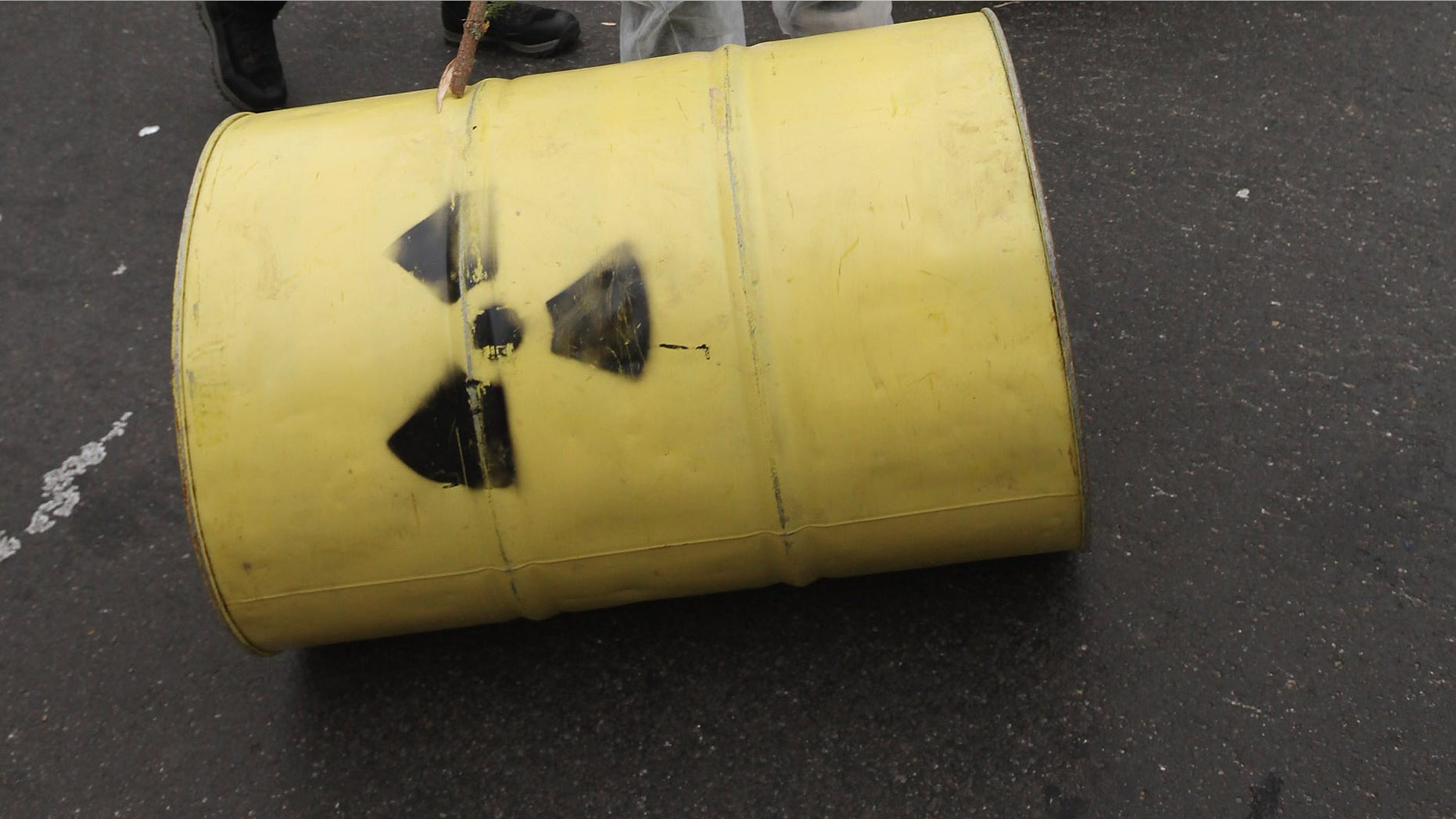 BERLIN, GERMANY - NOVEMBER 23: Anti-nuclear activists roll barrells with a radioactive symbol painted on them during a march in protest against the upcoming Castor nuclear waste transport on November 23, 2011 in Berlin, Germany. A train carrying the Castor containers of processed, spent nuclear fuel is due to start from La Hague in France today for its journey to the Gorleben temporary nuclear waste storage facility in Germany, and thousands of protesters are expected to attempt to blockade the route. (Photo by Sean Gallup/Getty Images)