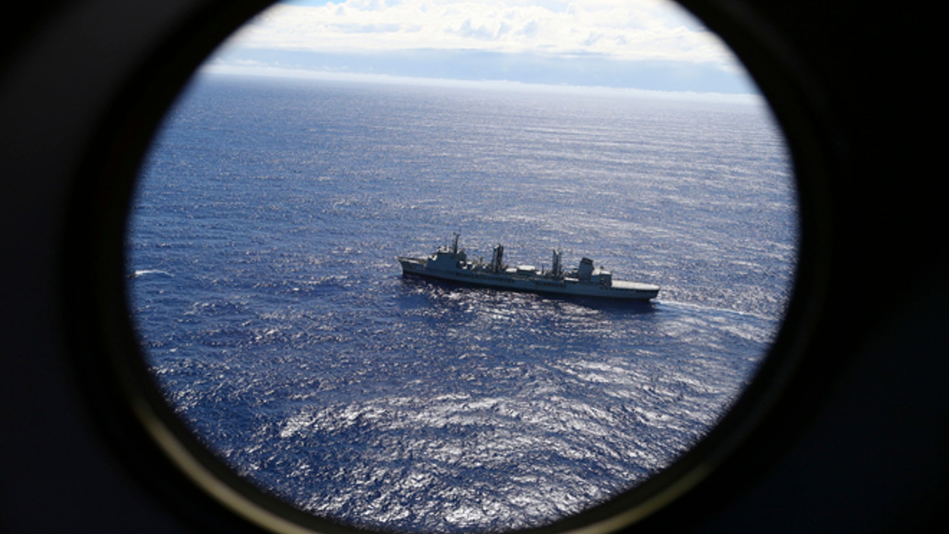 FILE - In this March 31, 2014 file photo, HMAS Success scans the southern Indian Ocean, near the coast of Western Australia, as a Royal New Zealand Air Force P3 Orion flies over, while searching for missing Malaysia Airlines Flight MH370.