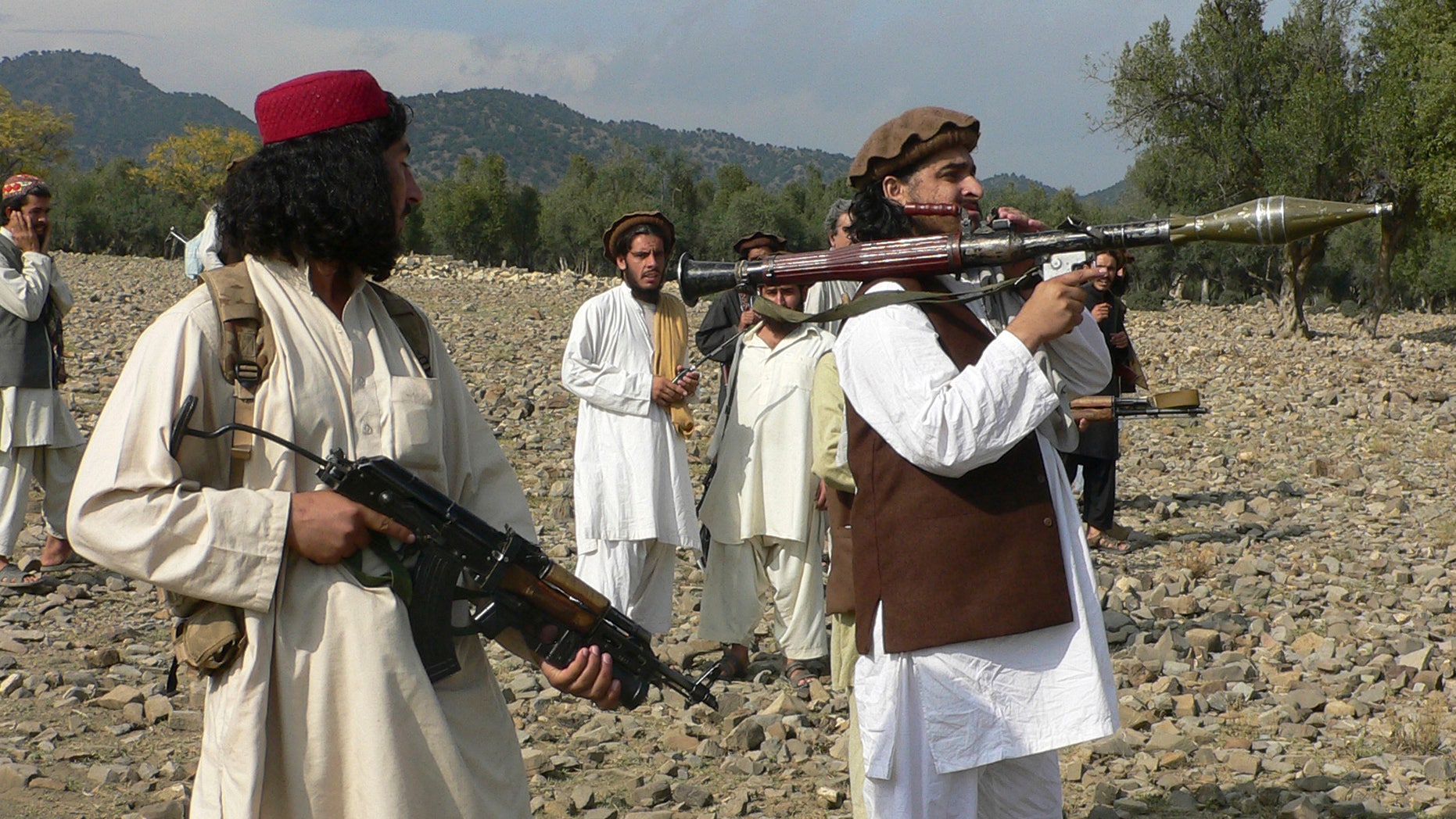 FILE - In this Sunday, Oct. 4, 2009 file photo, Pakistani Taliban chief Hakimullah Mehsud, right, holds a rocket launcher with his comrades in Sararogha of Pakistani tribal area of South Waziristan along the Afghanistan border. Intelligence officials said Friday, Nov. 1, 2013 that the leader of the Pakistani Taliban Hakimullah Mehsud was one of three people killed in a U.S. drone strike. (AP Photo/Ishtiaq Mehsud, File)