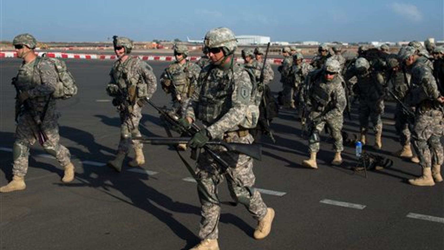 In this photo taken Wednesday, Dec. 18, 2013 and released by the U.S. Air Force, U.S. Army soldiers of the East Africa Response Force (EARF), a Djibouti-based joint team assigned to Combined Joint Task Force-Horn of Africa, prepare to load onto a U.S. Air Force C-130 Hercules at Camp Lemonnier, Djibouti, to support with an ordered departure of personnel from Juba, South Sudan. Gunfire hit three U.S. military CV-22 Osprey aircraft Saturday, Dec. 21, 2013 trying to evacuate American citizens in Bor, the capital of the remote region of Jonglei state in South Sudan, that on Saturday became a battle ground between South Sudan's military and renegade troops, officials said, with four U.S. service members wounded in the attack. (AP Photo/U.S. Air Force, Tech. Sgt. Micah Theurich)
