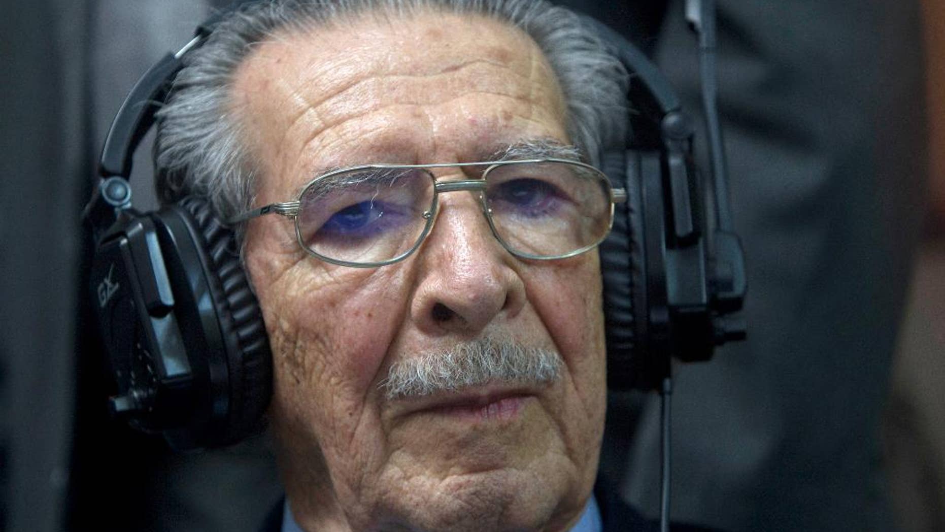 FILE - In this May 10, 2013 file photo, Guatemala's former dictator Jose Efrain Rios Montt wears headphones as he listens to the verdict in his genocide trial in Guatemala City. In an expert opinion dated July 1, 2015 and sent to the judge overseeing the first stage of Rios Montt’s case, the 89-year-old was determined by Guatemala’s National Institute of Forensic Sciences to be incapable of understanding the charges against him and of participating in his own defense. Prosecutors say Rios Montt is responsible for the deaths of almost 2,000 Mayan Indians, killed by the army between 1982 and 1983. (AP Photo/Moises Castilo, File)