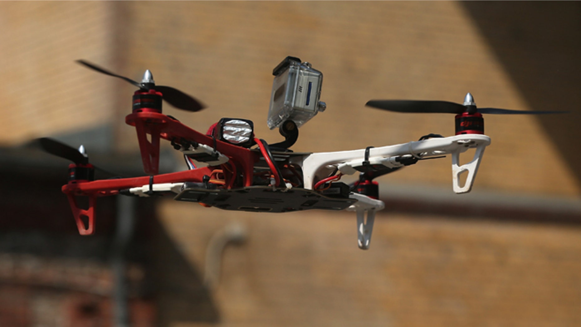 BERLIN, GERMANY - MAY 06: A quadrocopter drone flown remotely by a participant and equipped with a video camera flies on the first day of the re:publica 2013 conferences on May 6, 2013 in Berlin, Germany. Re:publica, a three-day-event, brings together bloggers and digitial media professionals for a series of conferences on affecting social, political and economic change through the Internet. (Photo by Sean Gallup/Getty Images)