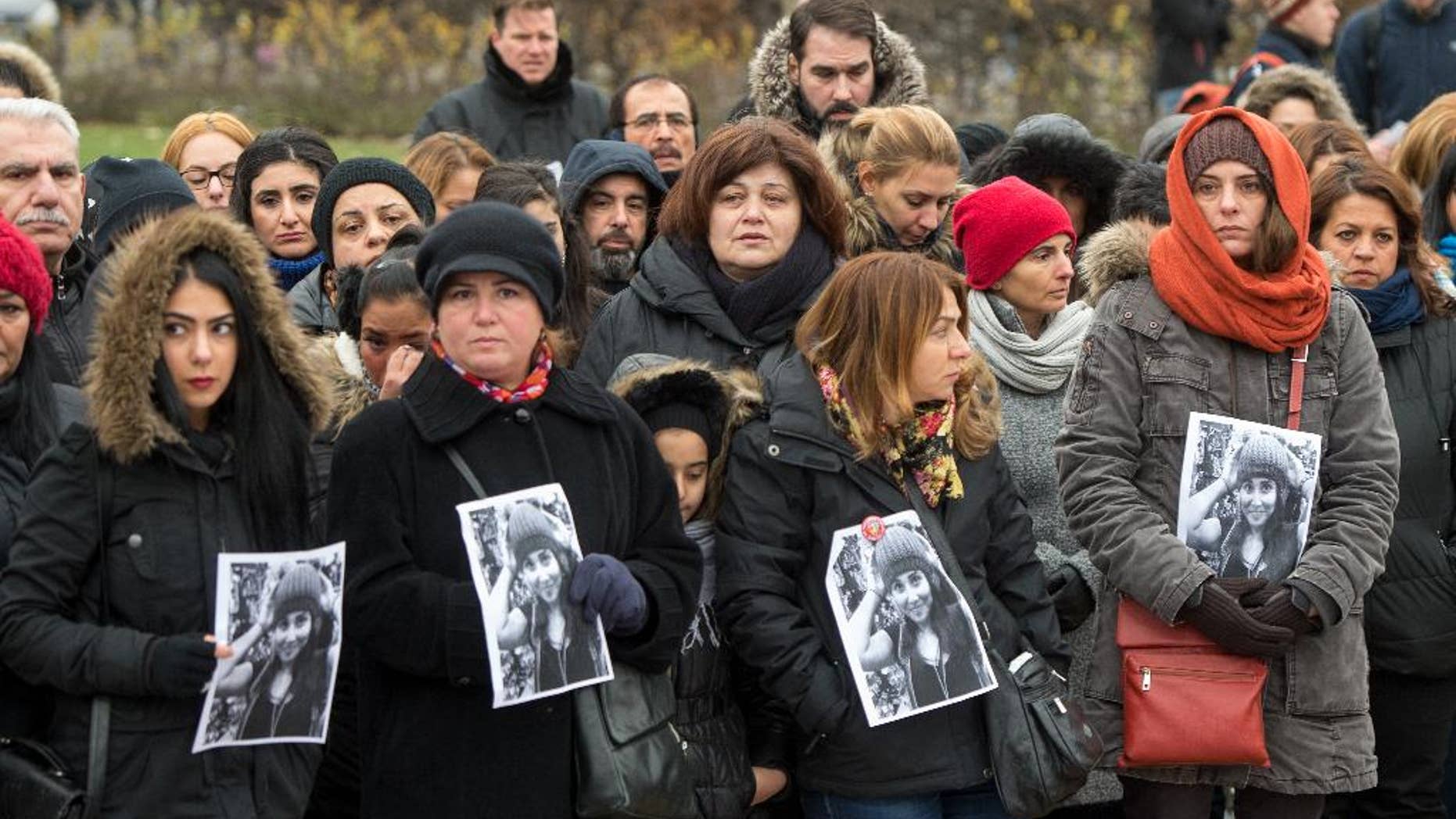Demonstrators take part in a rally while showing photographs to remember student Tugce in Berlin, Germany, Sunday Nov. 30, 2014. They commemorate 23-year old Tugce A. who was beaten up two weeks ago in front of a fast food branch when she tried to help two other girls in Offenbach, near Frankfurt Germany. She was declared brain dead and the medical equipment was switched off Friday which was also her 23. birthday. (AP Photo/dpa,Maurizio Gambarini)