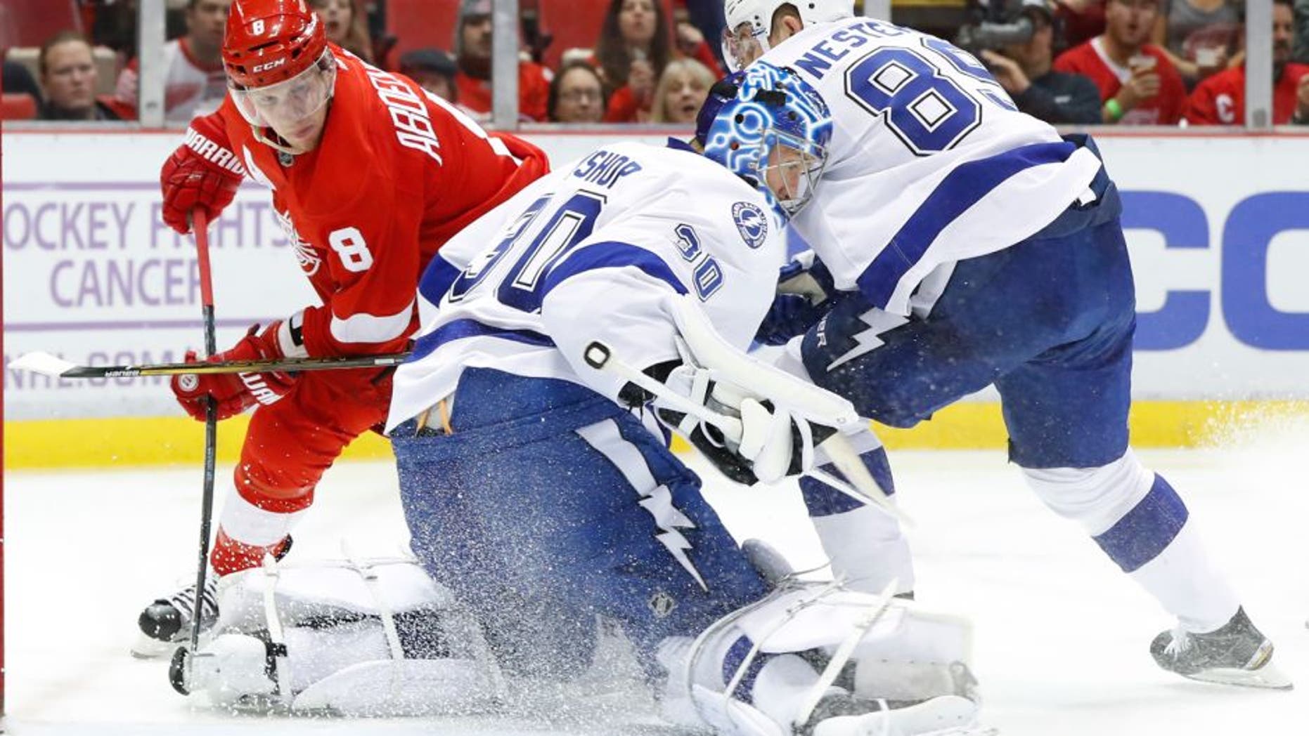 Tampa Bay Lightning goalie Ben Bishop (30) stops a Detroit Red Wings left wing Justin Abdelkader (8) shot in the second period of an NHL hockey game Tuesday, Nov. 15, 2016 in Detroit. (AP Photo/Paul Sancya)