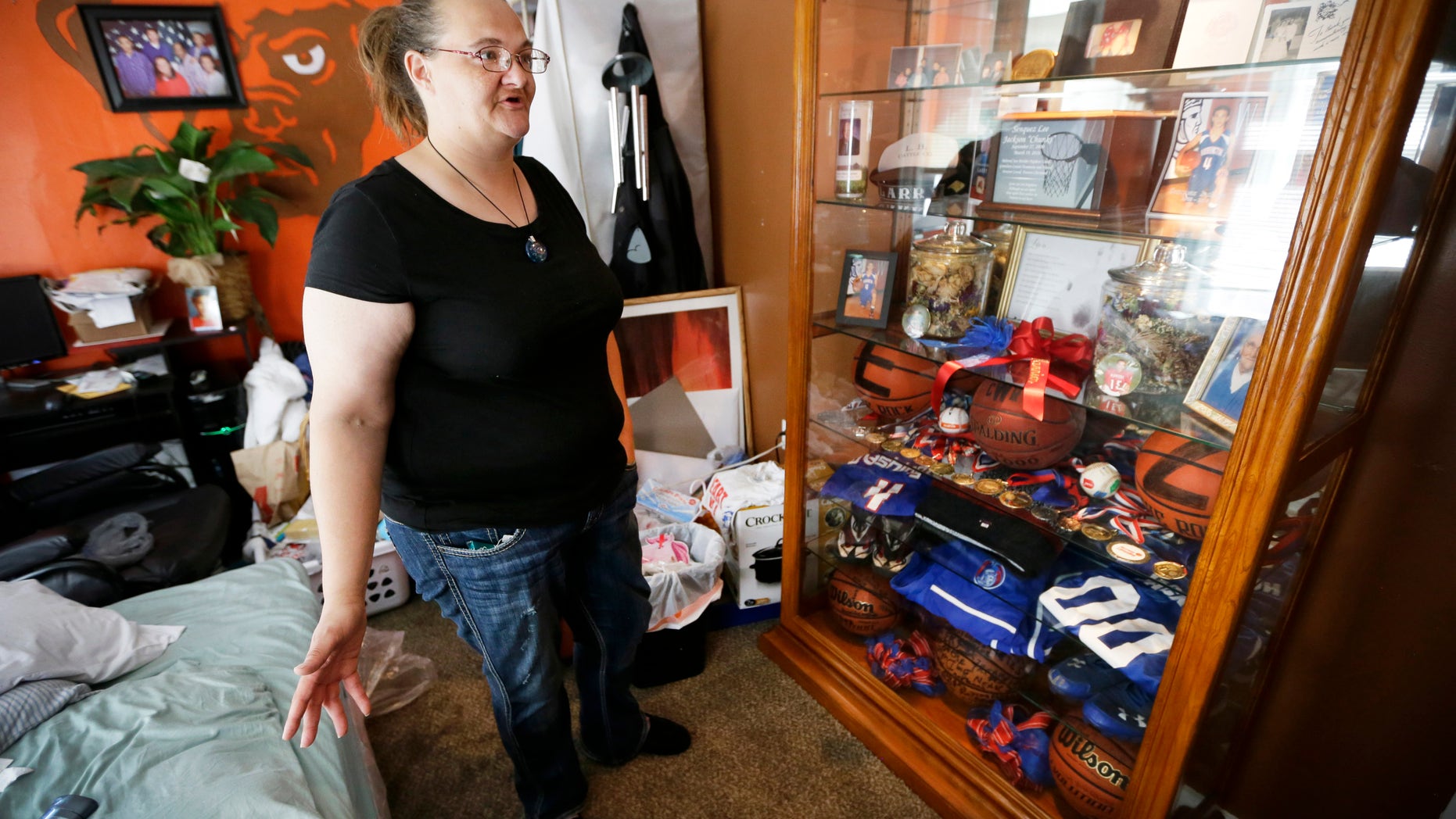 Tamara Bloemendaal talks about the death of her son, Senquez Jackson, in Cedar Rapids, Iowa, on June 21, 2016. The 15-year old was killed earlier in the year when a gun a friend was playing with accidentally discharged. Jolted awake by her older son, she recalls helping Senquez out of the recliner and watching him collapse on the floor in a pool of blood. She rode in the ambulance with the boy she called âChunksâ as a baby. Within hours, he was dead. (AP Photo/Charlie Neibergall)