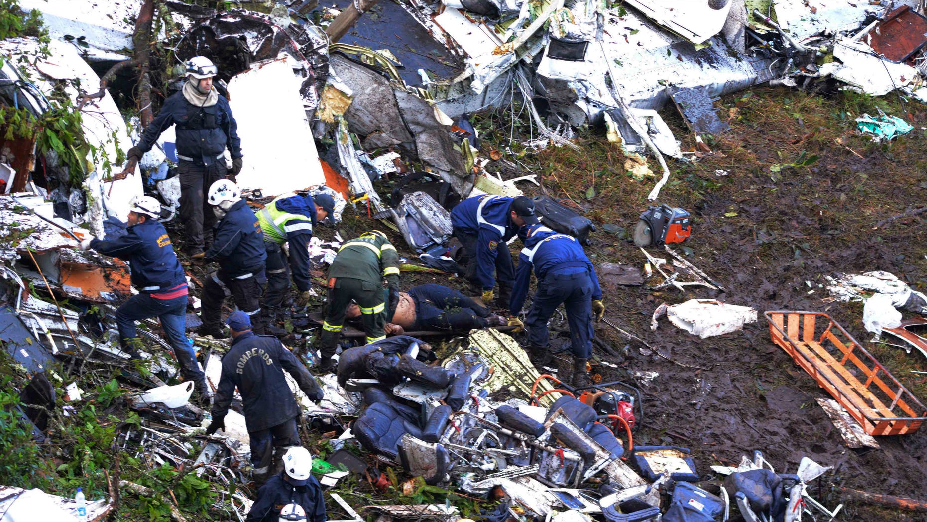 Rescue workers search for survivors outside Medellin, Colombia, Tuesday, Nov. 29, 2016.