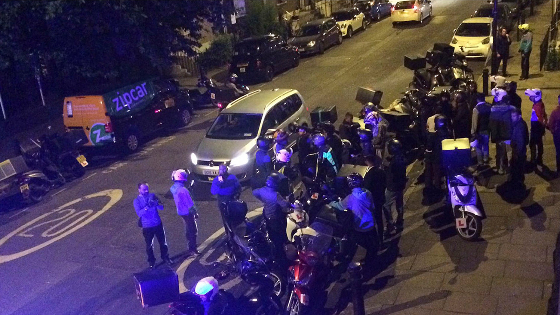 Authorities search the scene of an acid attack in London on July 13.