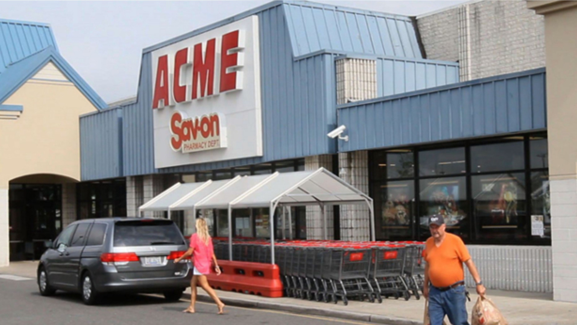 Aug. 8, 2013: Shoppers walk outside an Acme store on Route 9 in Little Egg Harbor, N.J., where one of the winning lottery tickets in the $448 million Powerball drawing was sold.