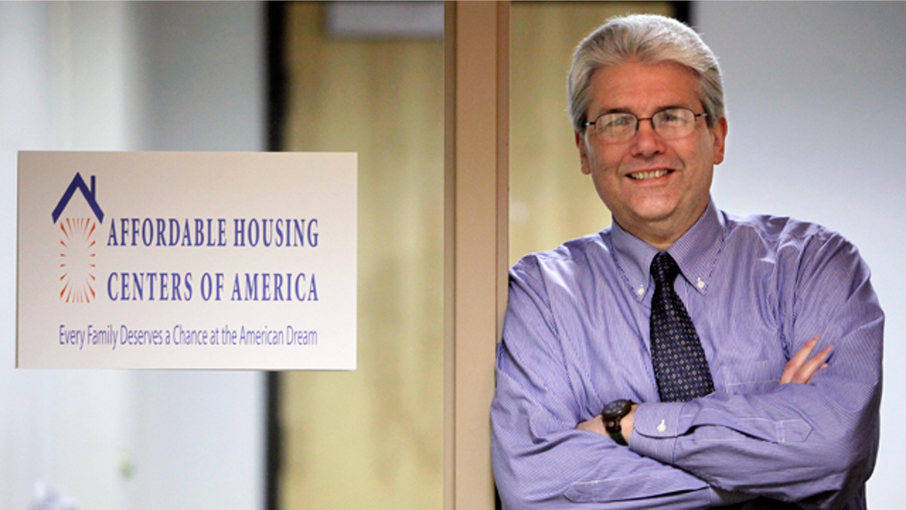 In this photo taken, March 12, 2010, in Chicago, Michael Shea, Executive Director of Affordable Housing Centers of America, formally known as ACORN Housing poses next to the organization's new sign. (AP)