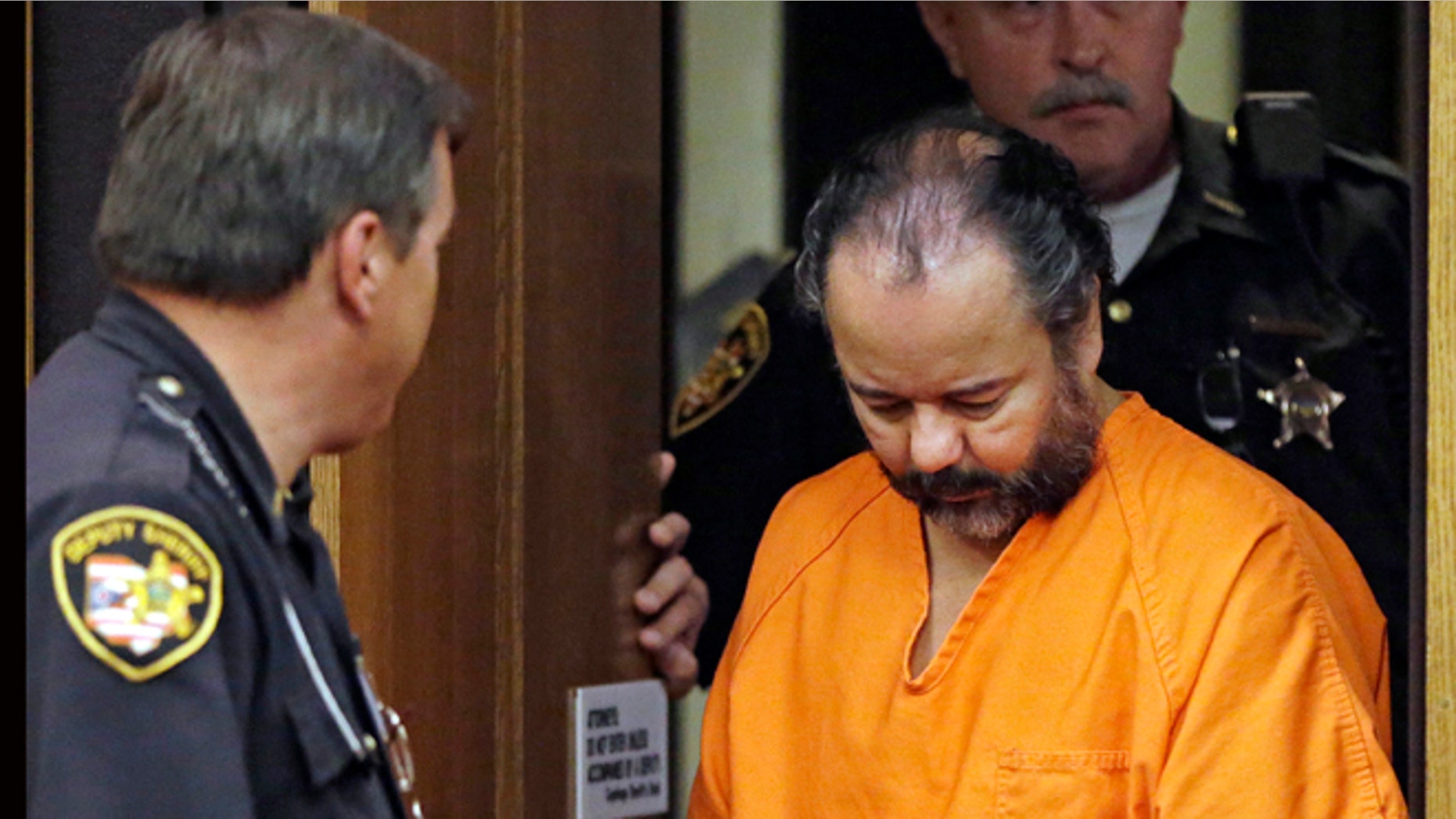 Ariel Castro is led into Cuyahoga County Common Pleas Court in Cleveland for a pretrial hearing on July 3, 2013.