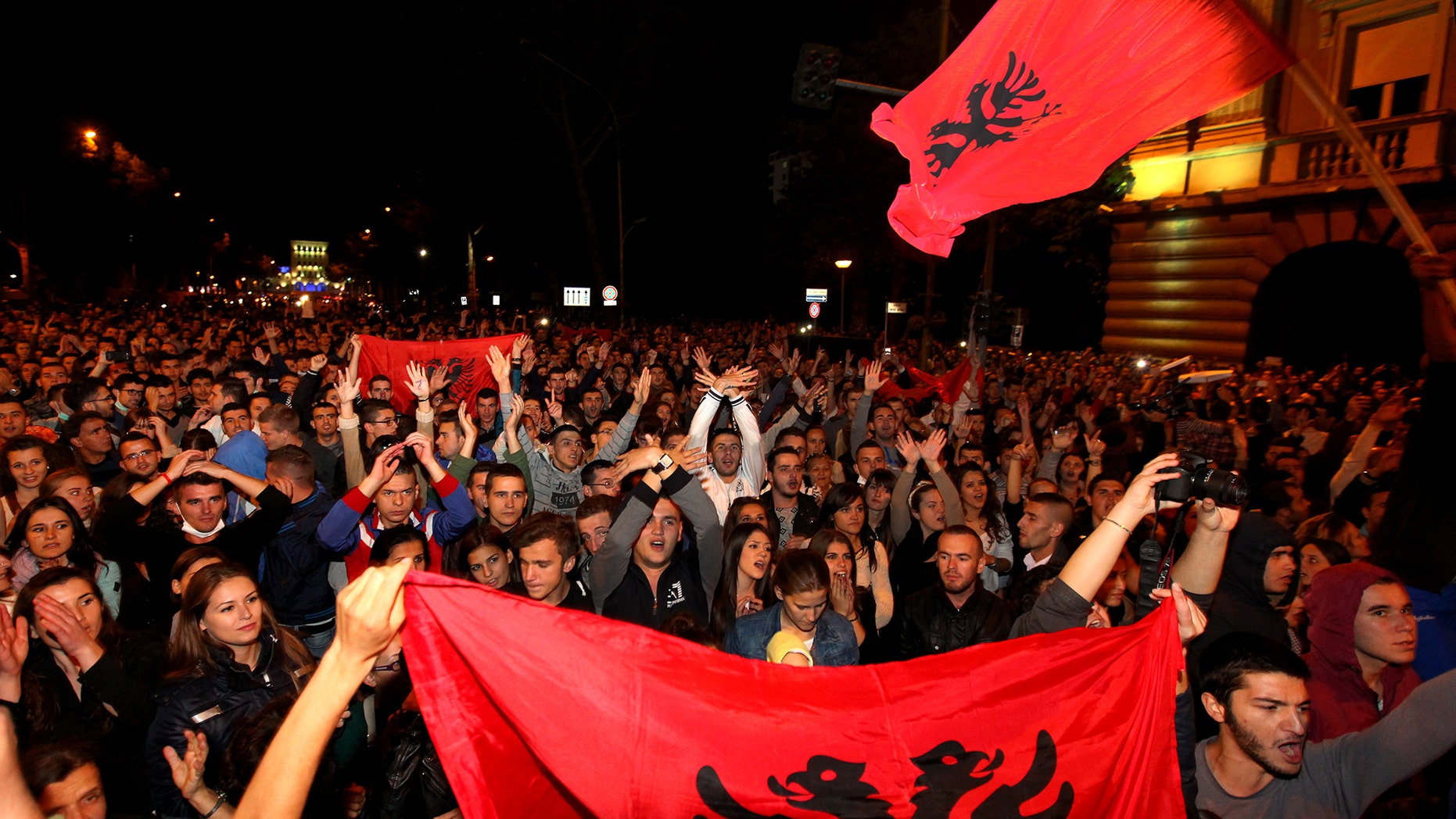 Thousands of Albanians in Tirana, Friday Nov. 15, 2013, greet the announcement by Prime Minister Edi Rama saying he turned down a request by the United States to be part of an operation to destroy Syria's chemical weapons stockpile, under the supervision of international experts. Albania, a NATO member, was seen as a possible choice since it recently destroyed its own poison gas arsenal. (AP Photo/Hektor Pusina)