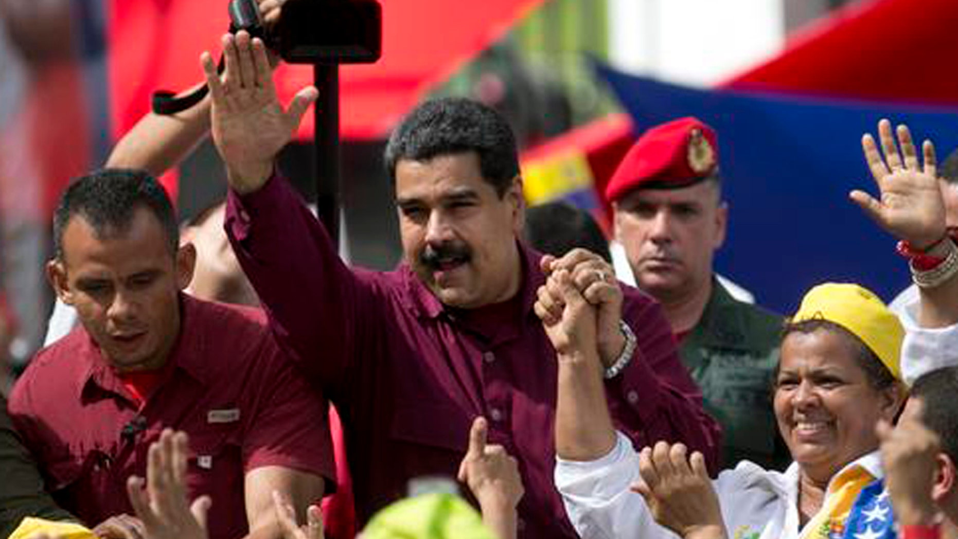 Venezuela's President Nicolas Maduro waves to supporters during a rally outside Miraflores presidential palace in Caracas, Venezuela, Friday, Oct. 28, 2016.