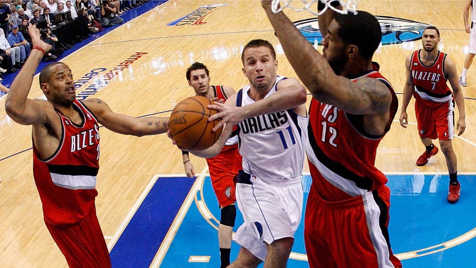 DALLAS, TX - APRIL 19: Guard Jose Juan Barea #11 of the Dallas Mavericks takes a shot against LaMarcus Aldridge #12 of the Portland Trail Blazers in Game Two of the Western Conference Quarterfinals during the 2011 NBA Playoffs on April 19, 2011 at American Airlines Center in Dallas, Texas. NOTE TO USER: User expressly acknowledges and agrees that, by downloading and or using this photograph, User is consenting to the terms and conditions of the Getty Images License Agreement. (Photo by Ronald Martinez/Getty Images)
