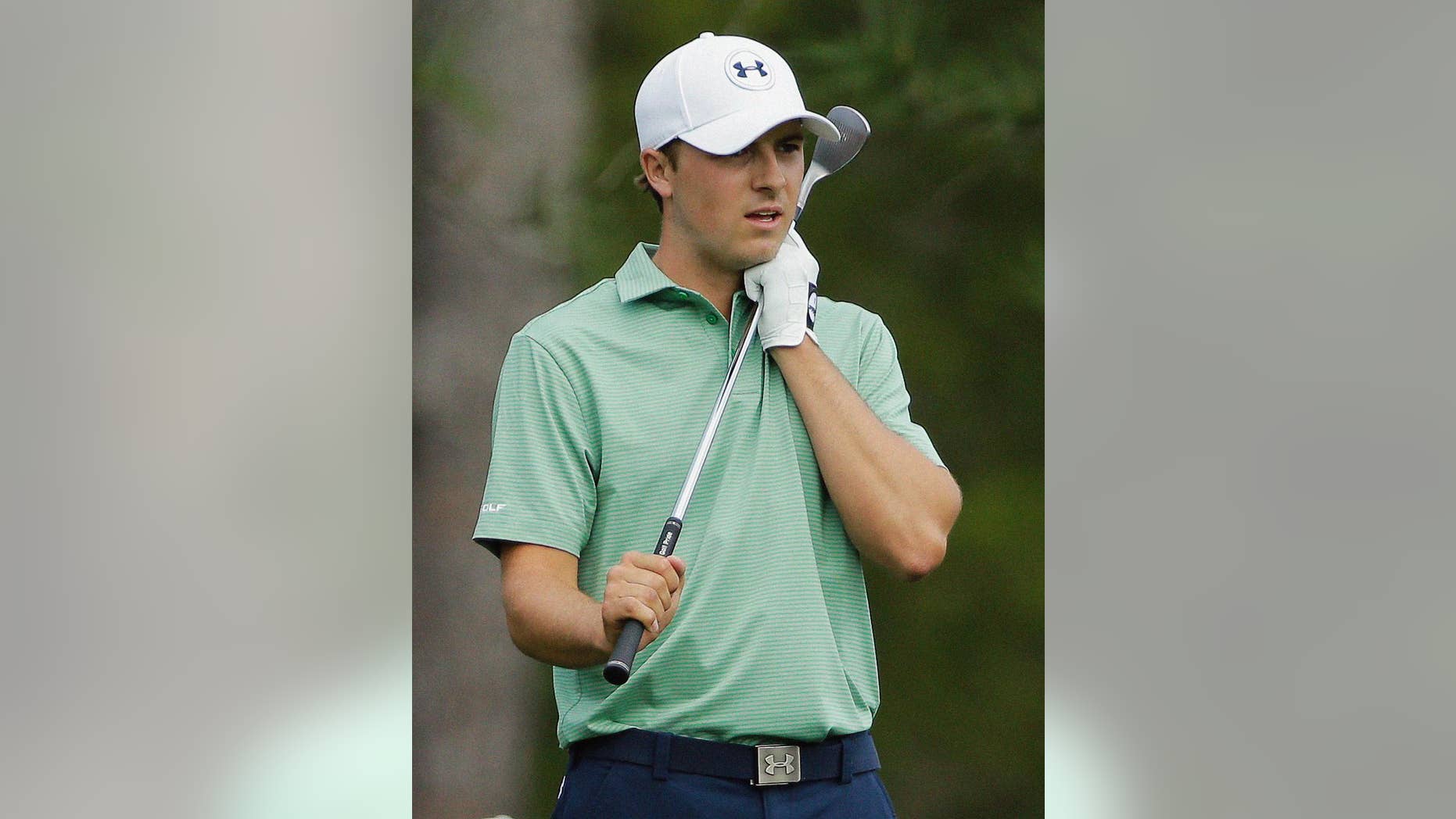 Jordan Spieth clutches his club after his approach shot on the eighth hole during the fourth round of the Masters golf tournament Sunday, April 13, 2014, in Augusta, Ga. (AP Photo/David J. Phillip)