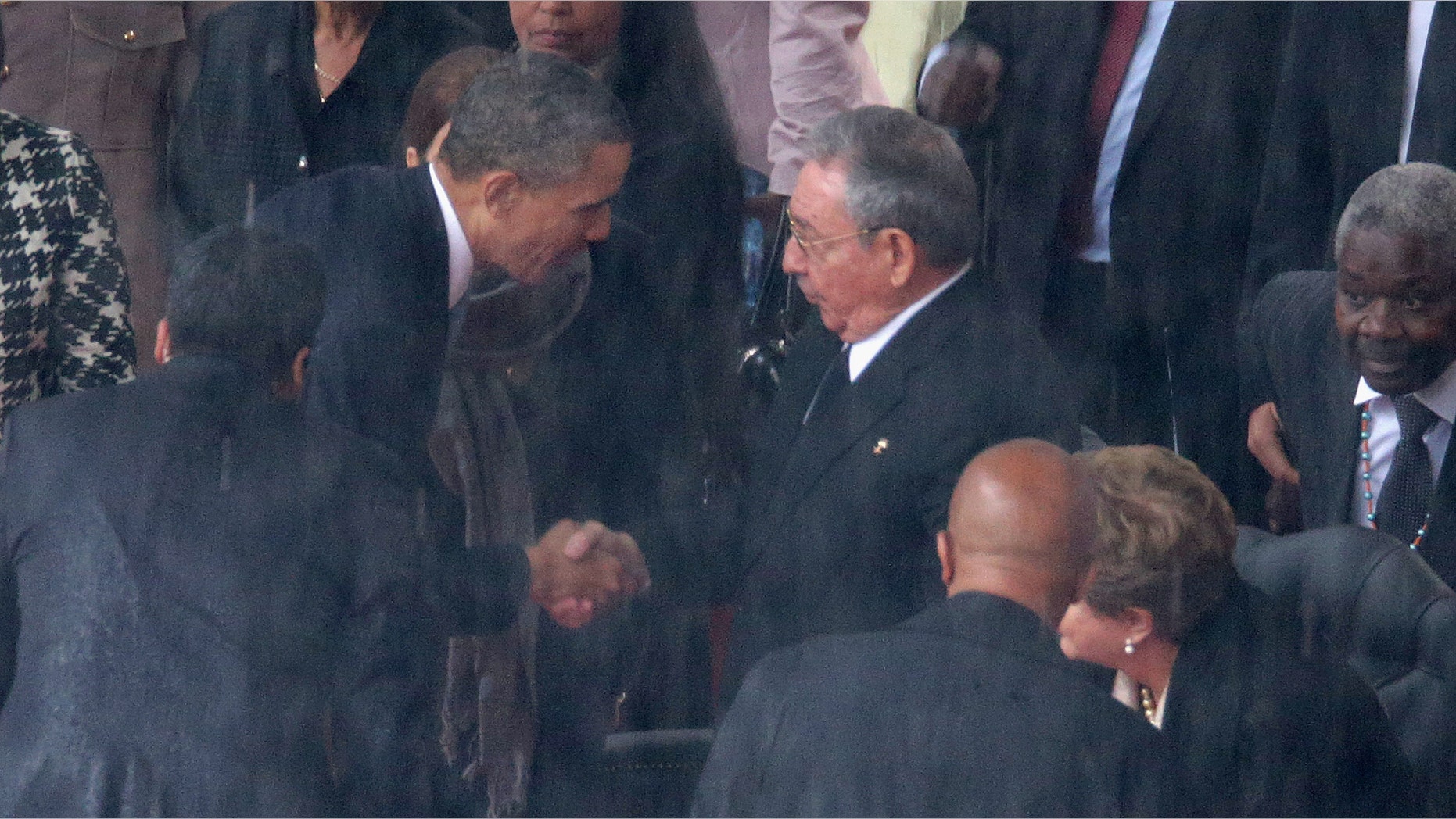 President Obama shakes hands with Cuban President Raul Castro on December 10, 2013 in Johannesburg, South Africa.