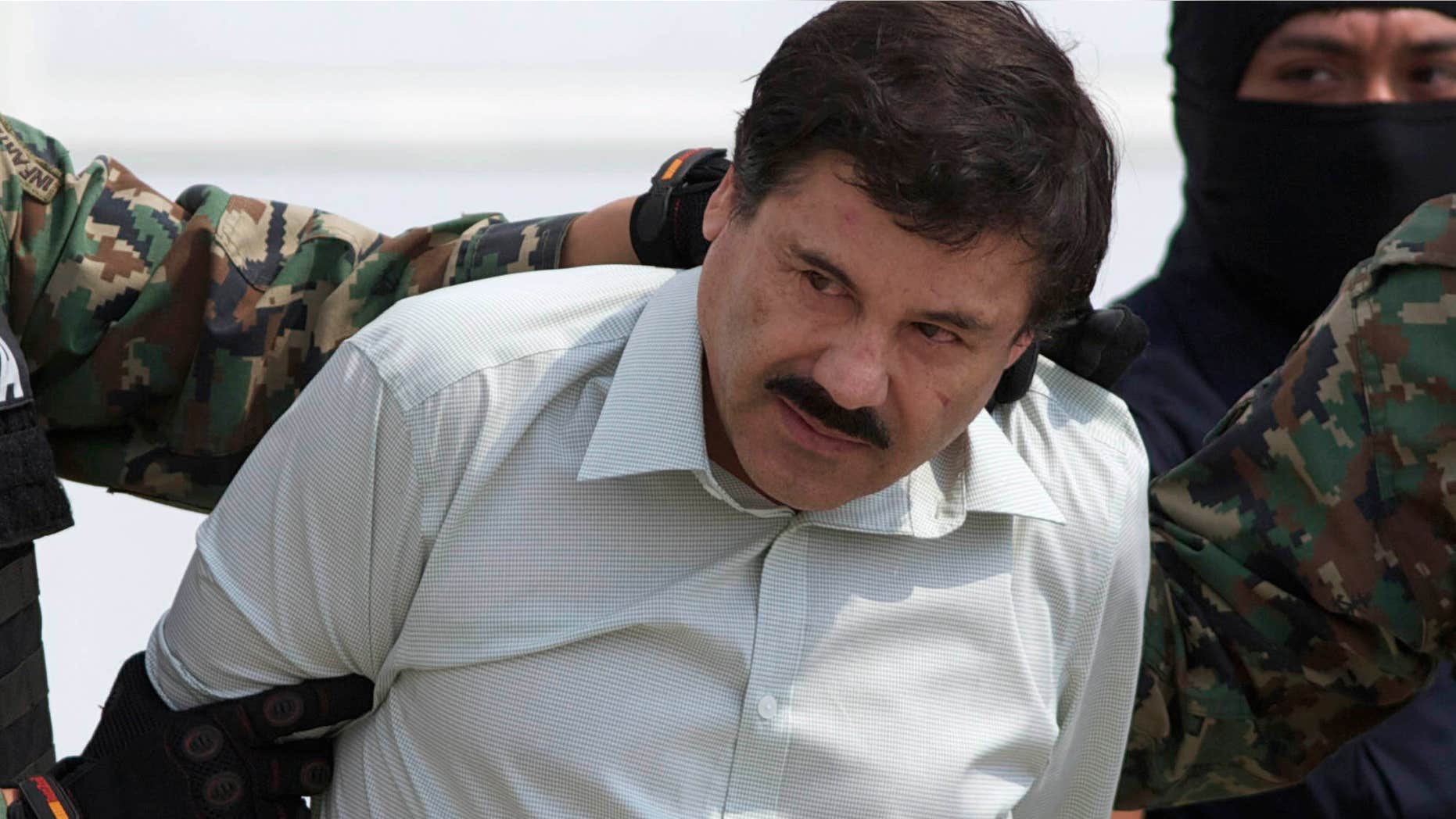FILE - This Feb. 22, 2014 file photo shows Joaquin "El Chapo" Guzman, the head of Mexico’s Sinaloa Cartel, being escorted to a helicopter in Mexico City following his capture overnight in the beach resort town of Mazatlan.