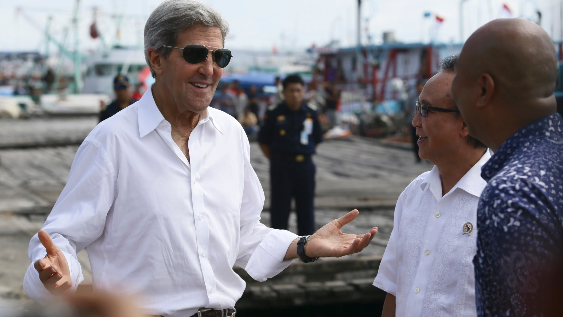 U.S. Secretary of State John Kerry speaks to officials during a visit to a tuna packaging factory in Bali, Indonesia, Sunday, Oct. 6, 2013. Kerry said Sunday that a pair of U.S. military raids against militants in North Africa sends the message that terrorists "can run but they can't hide." Kerry, in Bali for an economic summit, was the highest-level administration to speak about the operations yet. (AP Photo)