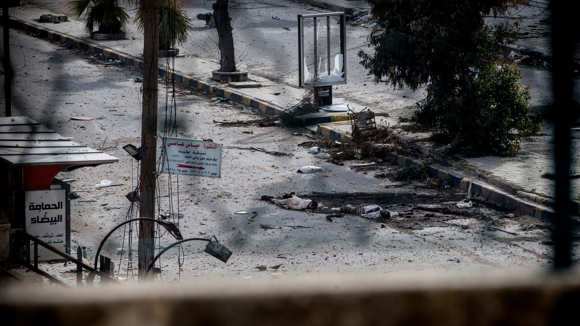 Two dead bodies lie on a street in the Saif al-Dawlah neighborhood of Aleppo, Syria, Sunday, Jan. 13, 2013. The revolution against the Syrian regime started in March 2011 with peaceful protests but morphed into a civil war that has killed more than 60,000 people, according to a recent United Nations estimate. (AP Photo/Andoni Lubaki)