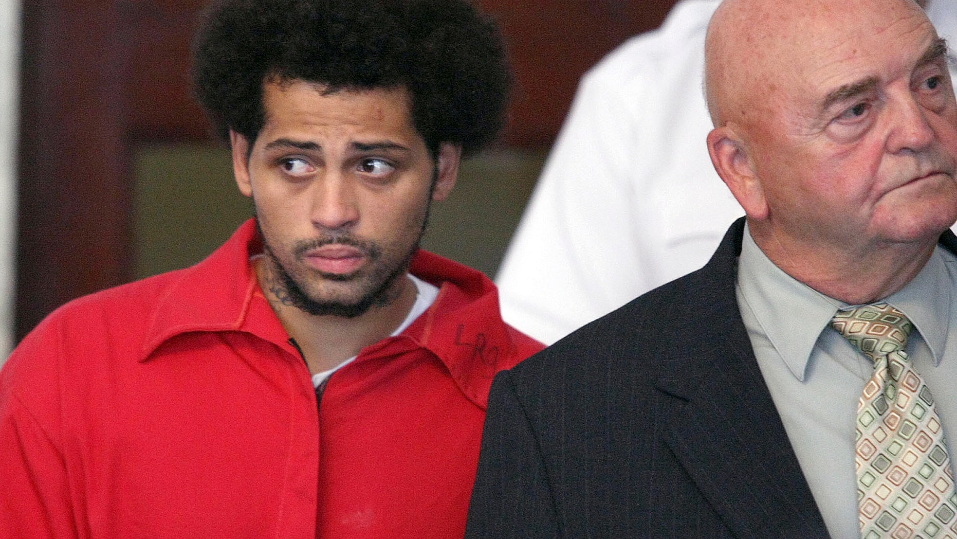 FILE - In this Friday, June 28, 2013 file photo, Carlos Ortiz, an associate of ex-New England Patriot Aaron Hernandez, left, enters the Attleboro District Court with attorney John Connors, right, for his arraignment on weapons charges, in Attleboro, Mass. Ortiz. who has been charged as an accessory to murder, is due in Fall River Superior Court Thursday afternoon, Jan. 9, 2014. (AP Photo/The Boston Globe, George Rizer, Pool, File)