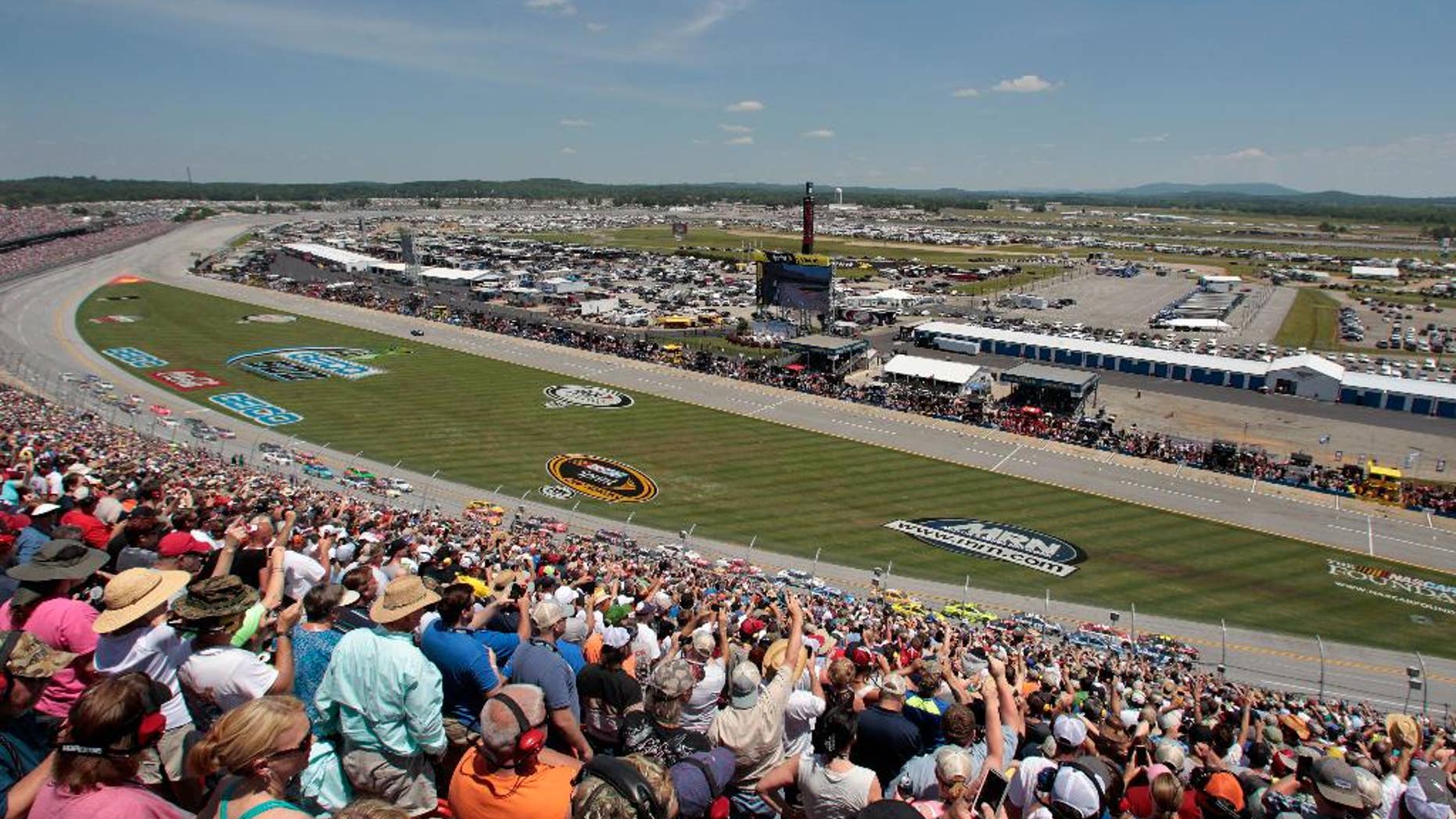 Race fans cheer the start of the Talladega 500 NASCAR Sprint Cup Series auto race at Talladega Superspeedway, Sunday, May 3, 2015, in Talladega, Ala. (AP Photo/Butch Dill)