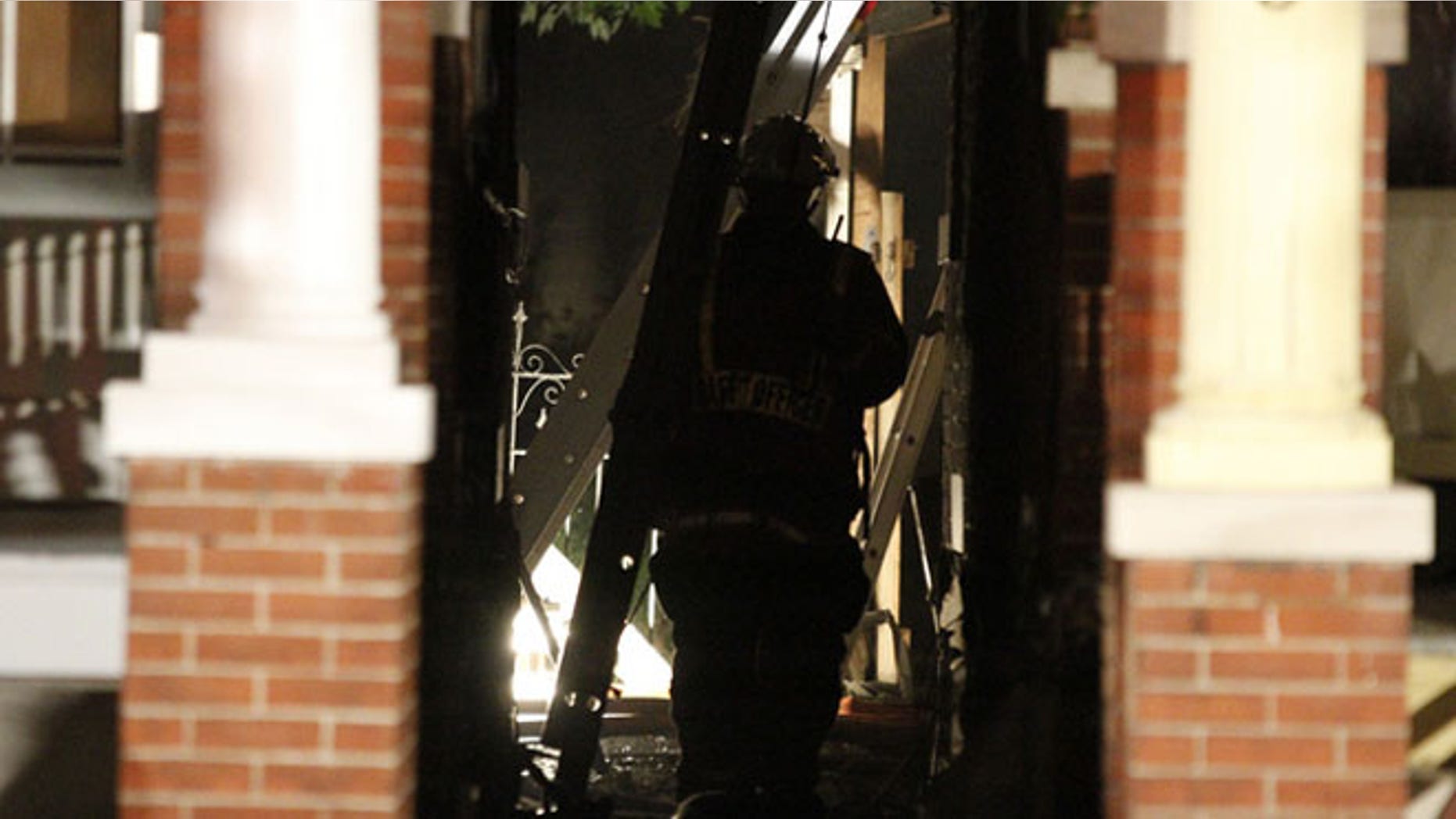July 4: Firefighters inspect a home where four people died in an early morning fire.