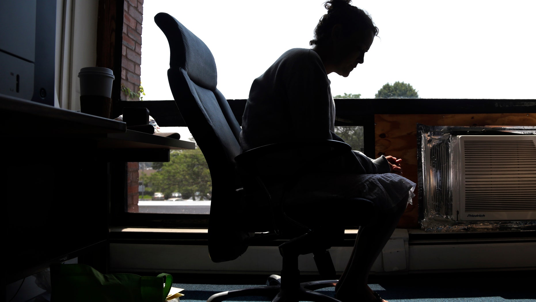 FILE- In this July 10, 2015, file photo a woman speaks to The Associated Press inside the police station in Gloucester, Mass. The woman voluntarily came to the police for help kicking her heroin addiction. A novel drug addiction program developed in the small Massachusetts fishing town, and since replicated in dozens of cities nationwide, was able to place almost 400 addicts into treatment nearly each time they sought it during the first year of operation, researchers say in a report being published Thursday, Dec. 22, 2016, in the New England Journal of Medicine. (AP Photo/Elise Amendola, File)