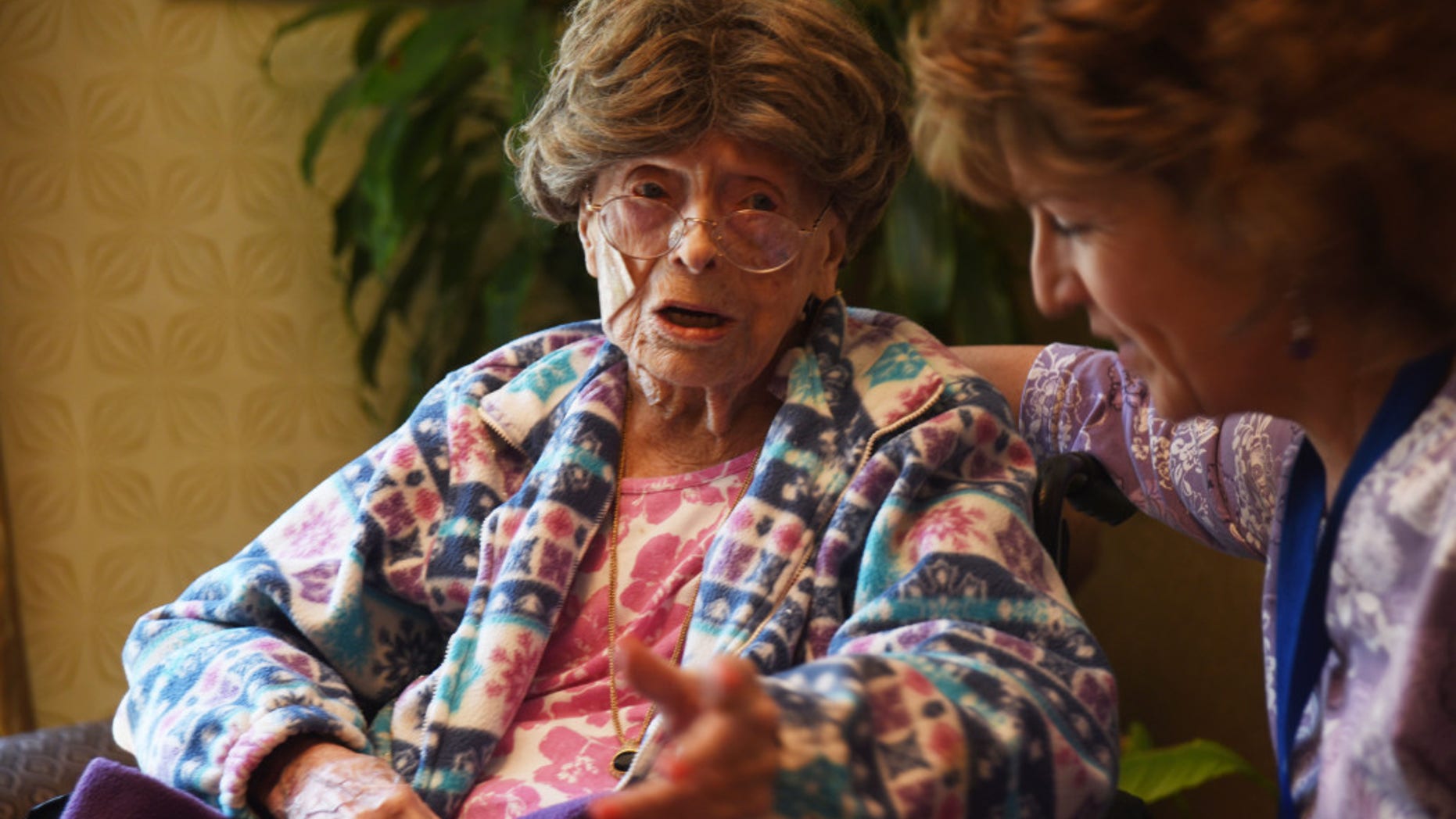Adele Dunlap, 113, talks to a caregiver in Pittstown, N.J.