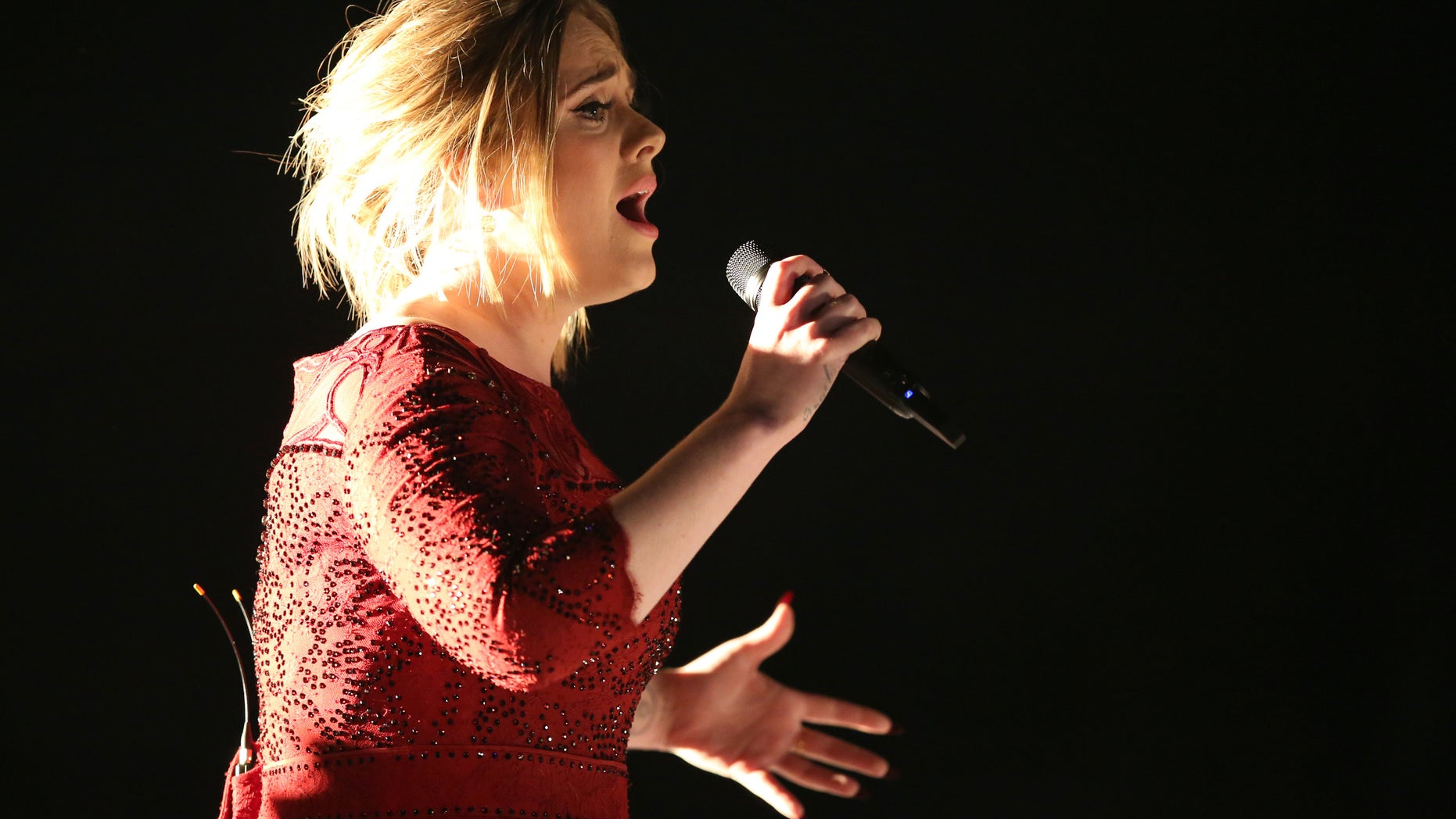 FILE - In this Feb. 15, 2016, file photo, Adele performs at the 58th annual Grammy Awards in Los Angeles. A video posted by a fan on Twitter May 29, 2016, shows the singer calling out a fan for filming her concert. (Photo by Matt Sayles/Invision/AP, File )