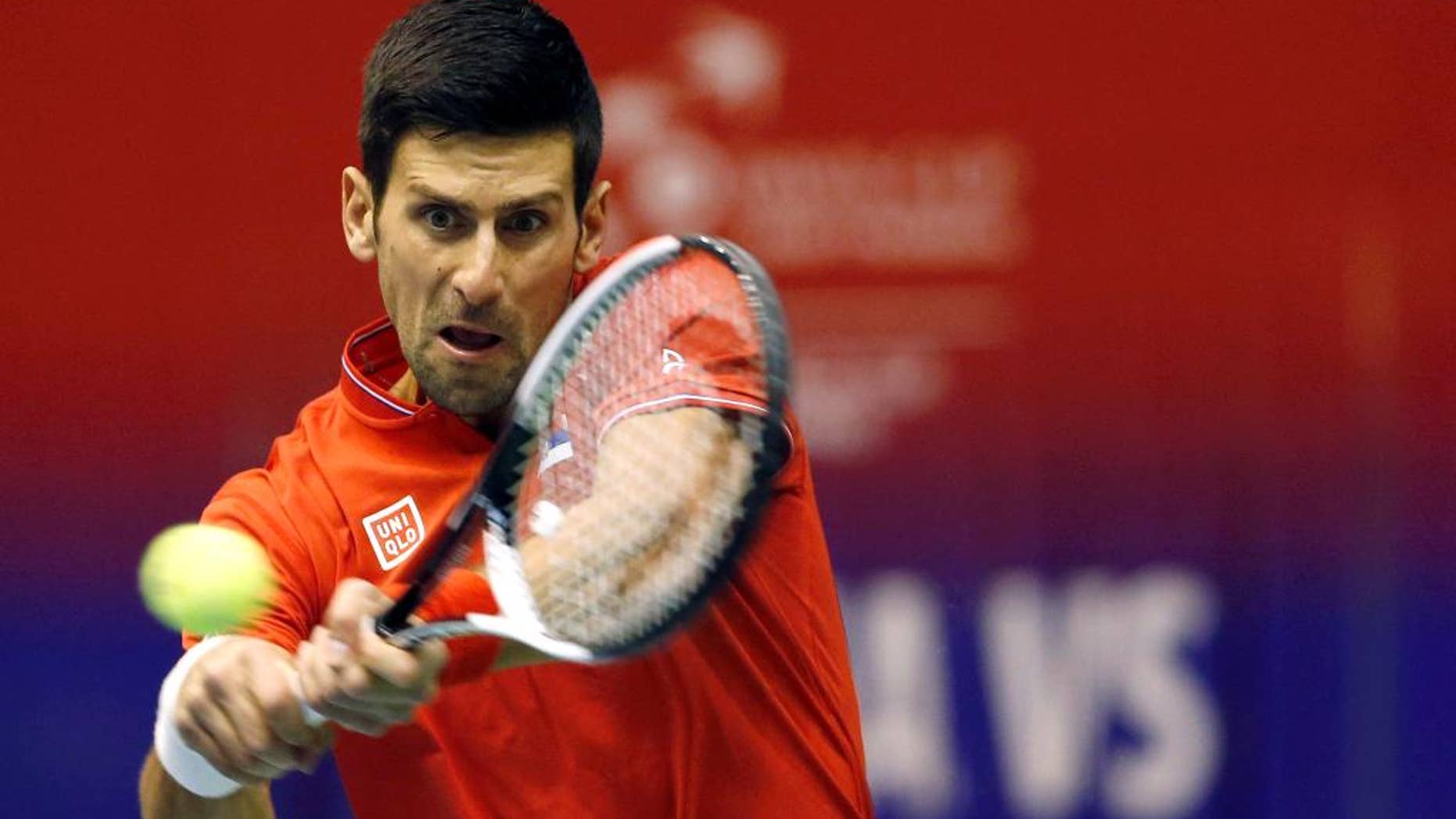 FILE - In this April 7, 2017 file photo, Serbia's Novak Djokovic returns the ball to Spain's Albert Ramos-Vinolas during their Davis Cup quarterfinal tennis match, in Belgrade, Serbia. Djokovic has split with his longtime coach Marian Vajda and two other team members, saying he wants to find "the winning spark on the court again." Djokovic said on his website on Friday, May 5 that he "mutually agreed" with Vajda, fitness coach Gebhard Phil Gritsch, and physiotherapist Miljan Amanovic to end their "successful and long term partnership" two weeks ago after the Monte Carlo Masters, where he lost in quarterfinals. (AP Photo/Darko Vojinovic, File)
