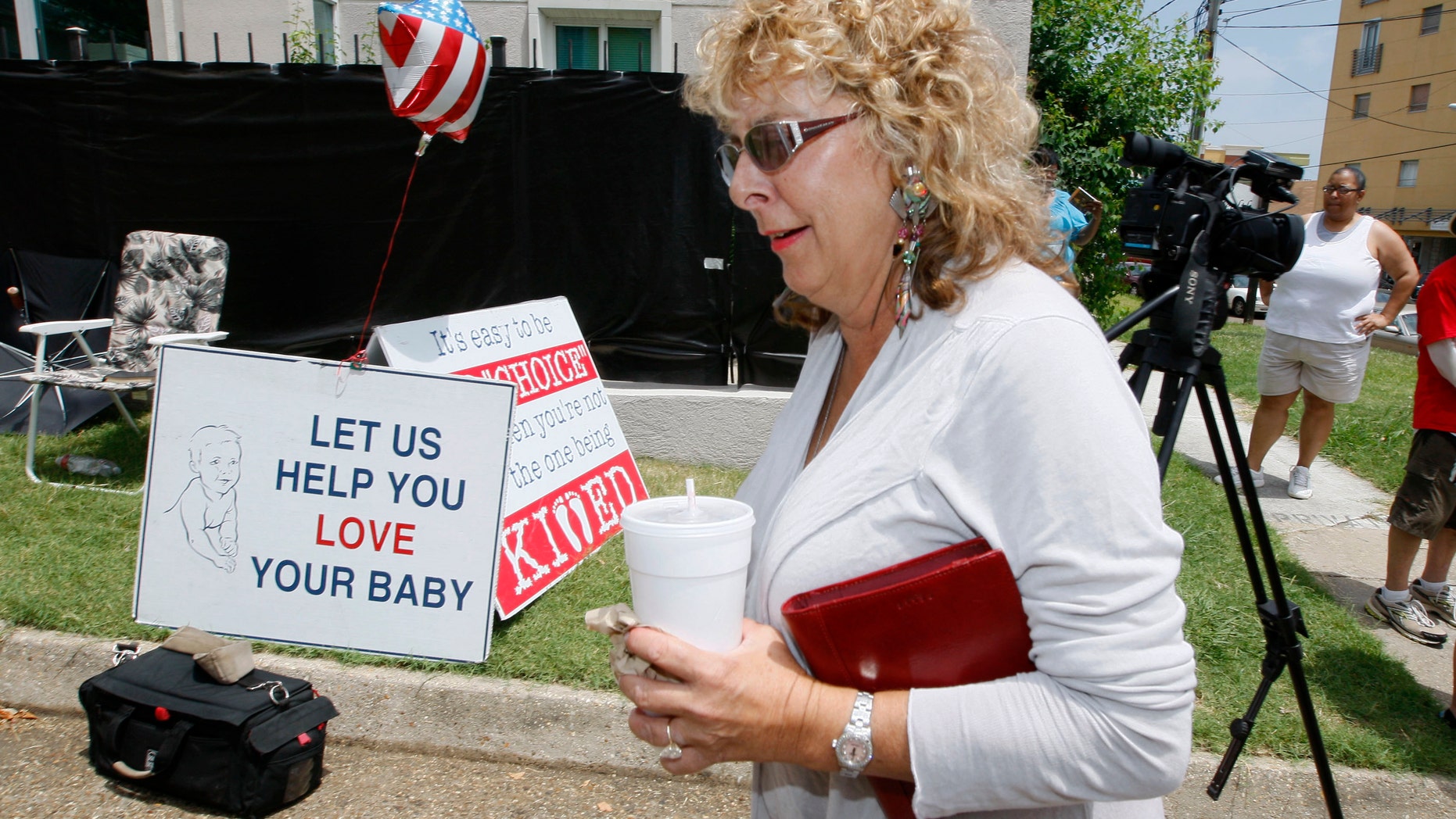 July 2- Jackson Women's Health Organization owner Diane Derzis, walks past abortion opponents protesting outside Mississippi's only abortion clinic in Jackson, Miss.