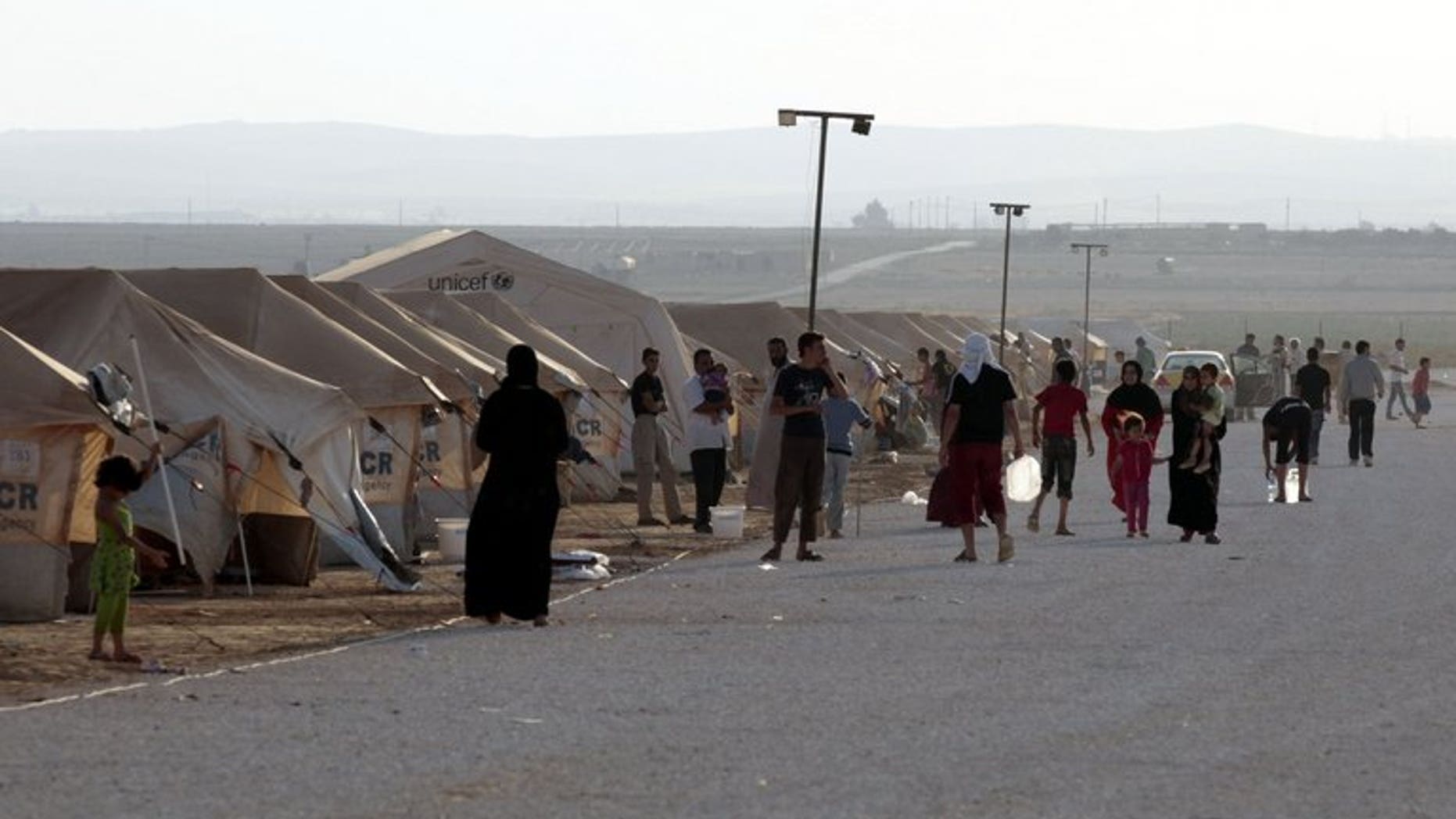 Syrian refugees gather at the Zaatari camp in Jordan, on July 31, 2012