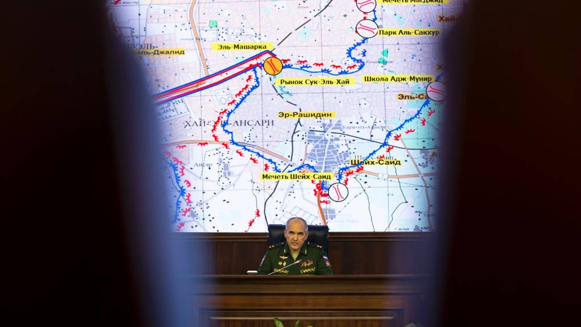 Lt. Gen. Sergei Rudskoi of the Russian military's General Staff speaks in front of a map of the Aleppo area, at a briefing at the Russian Defense Ministry's headquarters in Moscow, Russia, Wednesday, Oct. 19, 2016. The Russian military says that Russian and Syrian warplanes are staying away from Aleppo a day before a temporary pause in the military push declared by Moscow. Lt. Gen. Sergei Rudskoi said the "humanitarian pause" in Aleppo will last from 8 a.m. to 7 p.m. Thursday, three hours longer than the Russian military initially announced. (AP Photo/Alexander Zemlianichenko)