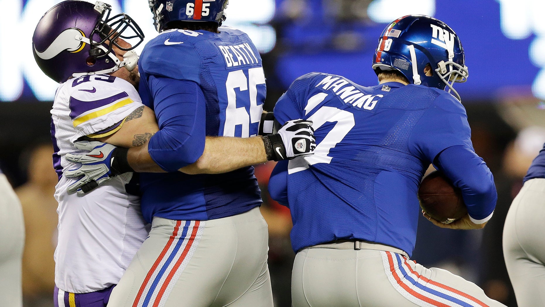 Minnesota Vikings defensive end Jared Allen (69) sacks New York Giants quarterback Eli Manning (10) as tackle Will Beatty (65) attempts to block him during the first half of an NFL football game Monday, Oct. 21, 2013 in East Rutherford, N.J. (AP Photo/Julio Cortez)