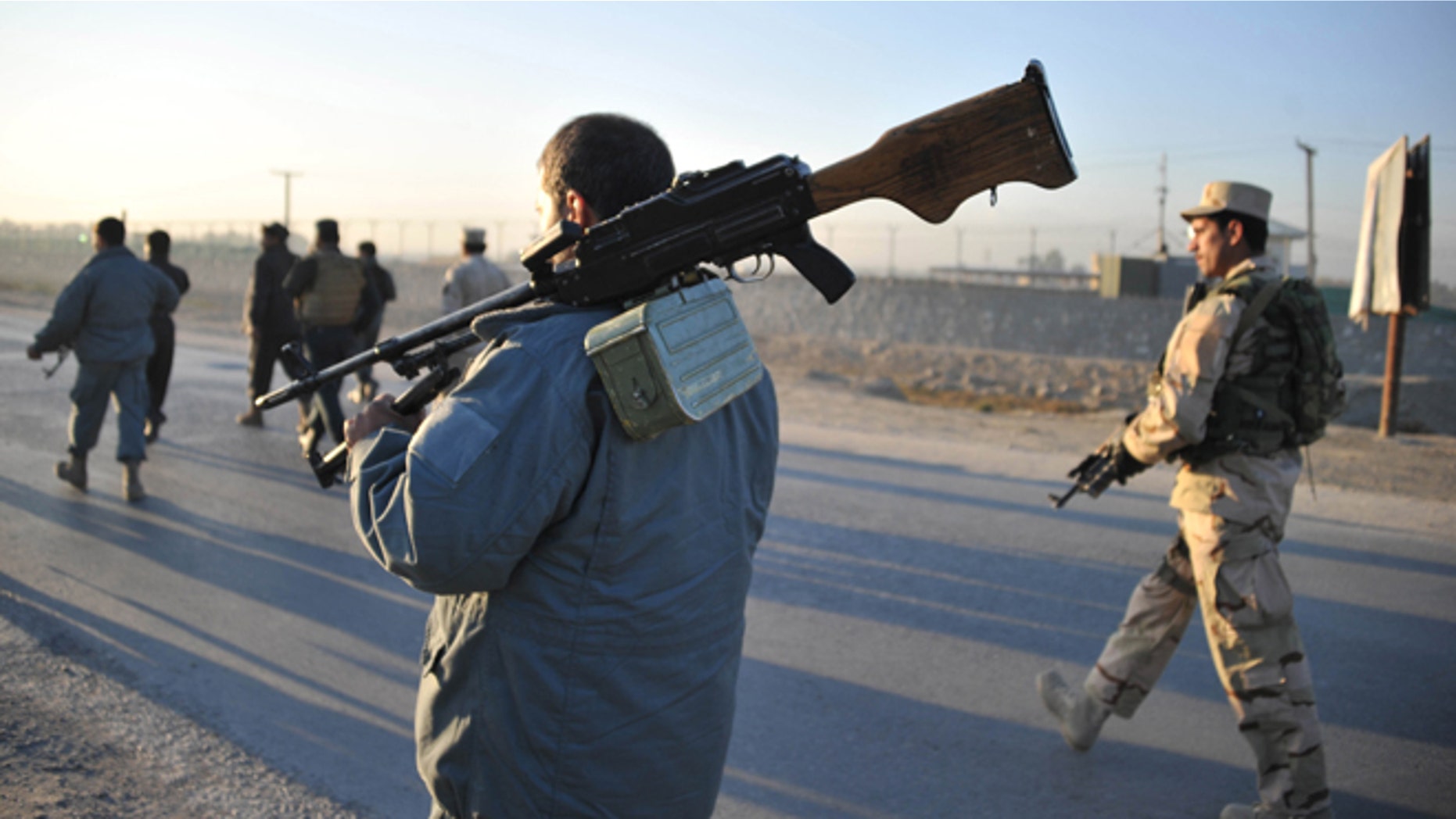 Dec. 2, 2012: Afghan security forces patrol the site where Taliban suicide bombers attacked a joint U.S.-Afghan air base in Jalalabad, east of Kabul, Afghanistan.