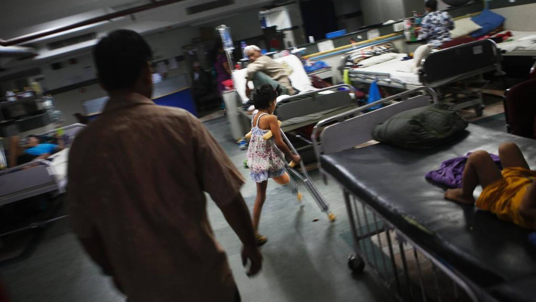 In this July 6, 2015 photo, Nepal earthquake survivor Nirmala Pariyar, 8, practices using her crutches to move around at the Bir Trauma Center in Kathmandu, Nepal. Nirmala lost one leg in Nepal's massive April 25, 2015 earthquake that killed nearly 9,000 people and left more than 22,000 injured. (AP Photo/Niranjan Shrestha)