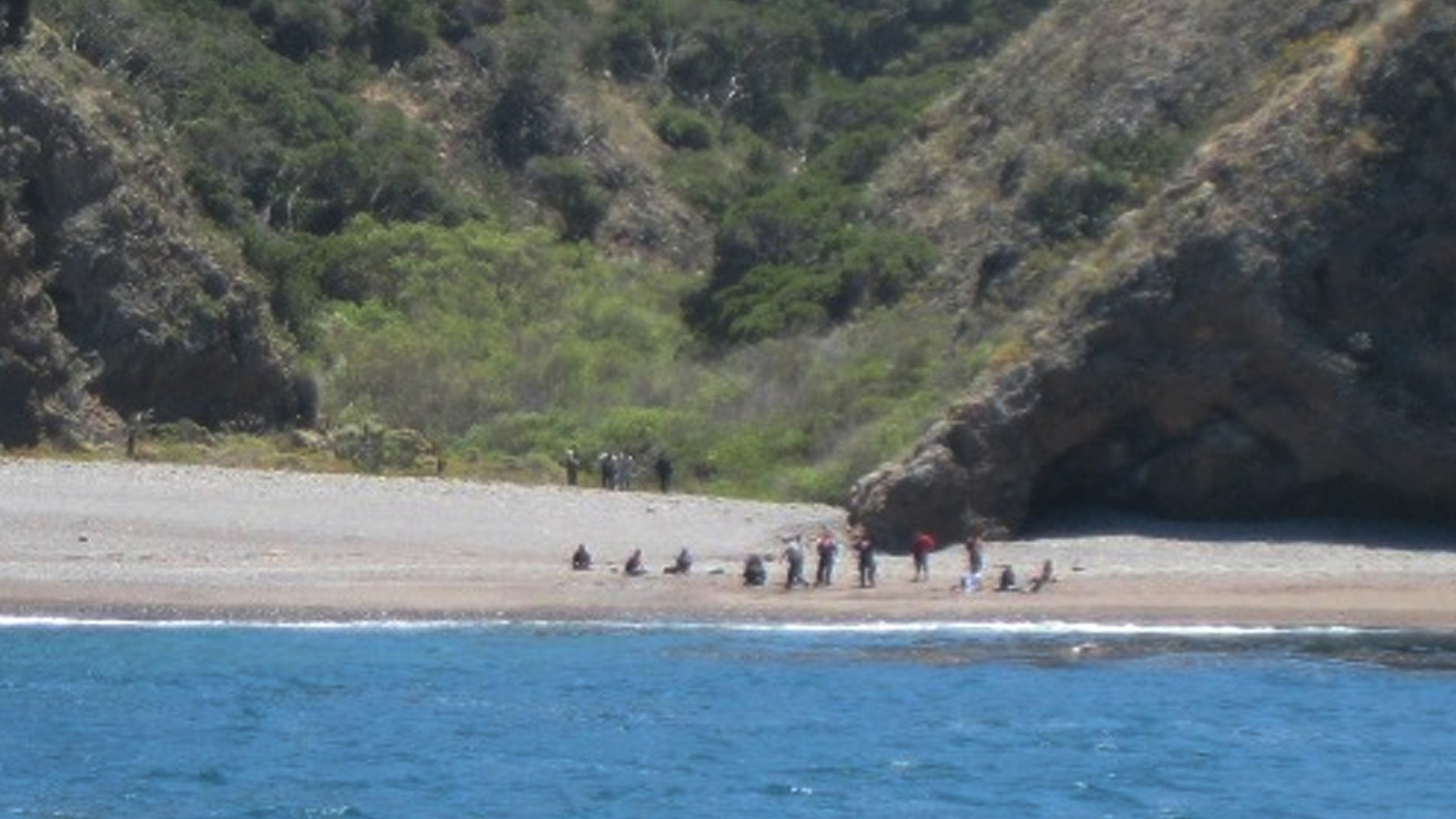 July 11: Coast Guard and National Park Service personnel with the apprehension of 15 suspected illegal migrants, near Santa Cruz Island, Calif.
