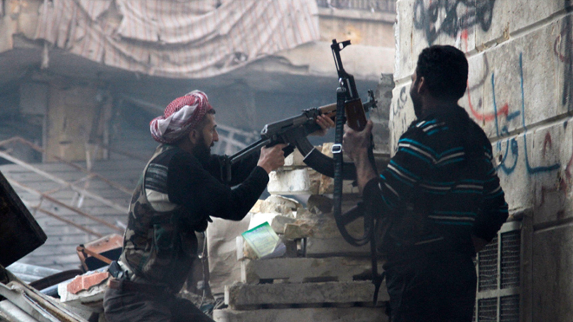 Free Syrian Army fighters fire at enemy positions during heavy clashes with government forces, in the Salaheddine district in Aleppo, Syria. Weapons and money are now flowing in from Kuwait. (AP)