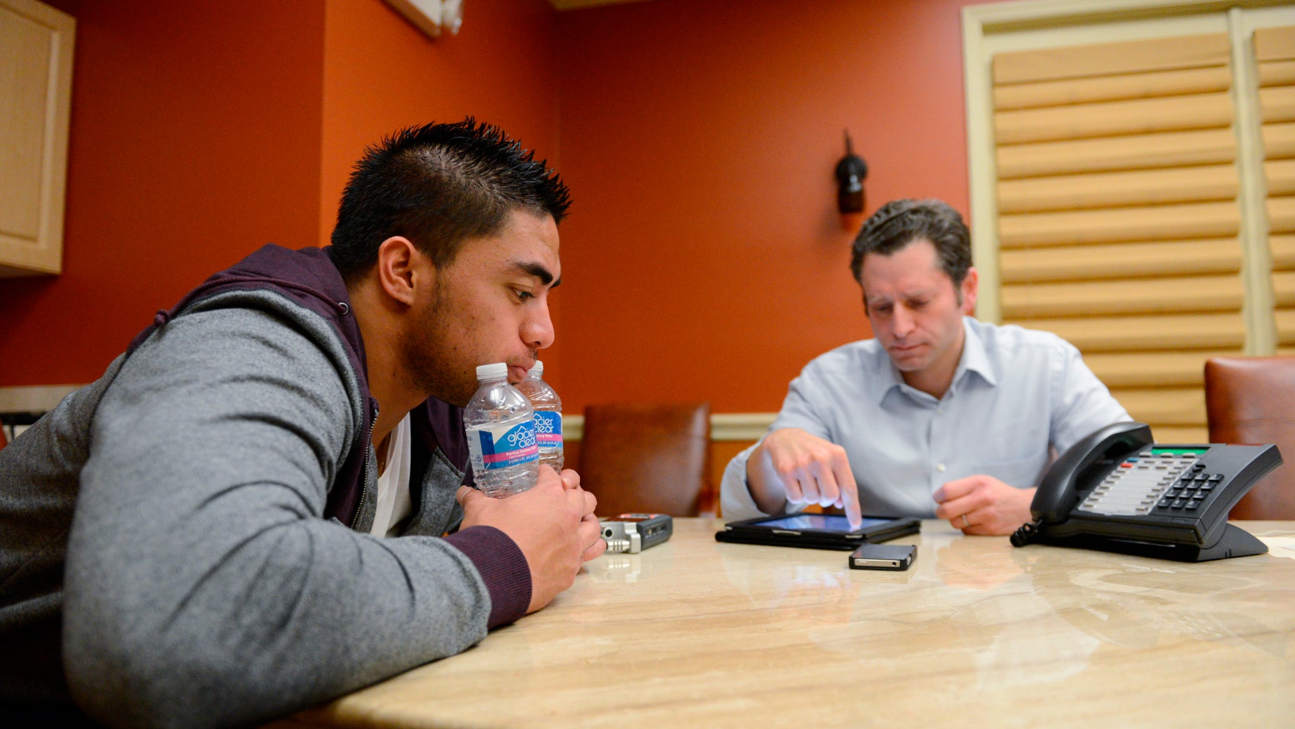 In a photo provided by ESPN, Notre Dame linebacker Manti Te'o pauses during an interview with ESPN's Jeremy Schaap, right, on Friday, Jan. 18, 2013, in Bradenton, Fla. ESPN says Te'o maintains he was never involved in creating the dead girlfriend hoax. He said in the off-camera interview: "When they hear the facts they'll know. They'll know there is no way I could be a part of this." (AP Photo/ESPN Images, Ryan Jones) MANDATORY