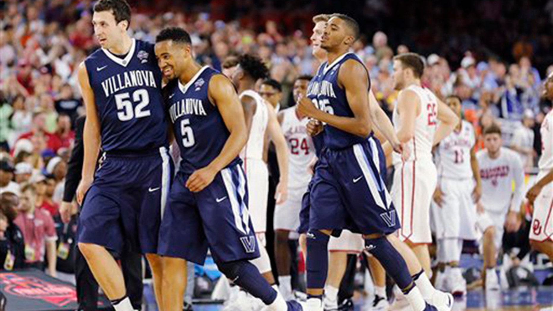 Villanova players including Phil Booth (5) and Kevin Rafferty (52) walks off the court after an NCAA Final Four tournament college basketball semifinal game against Oklahoma Saturday, April 2, 2016, in Houston. Villanova won 95-51.(AP Photo/Kiichiro Sato)