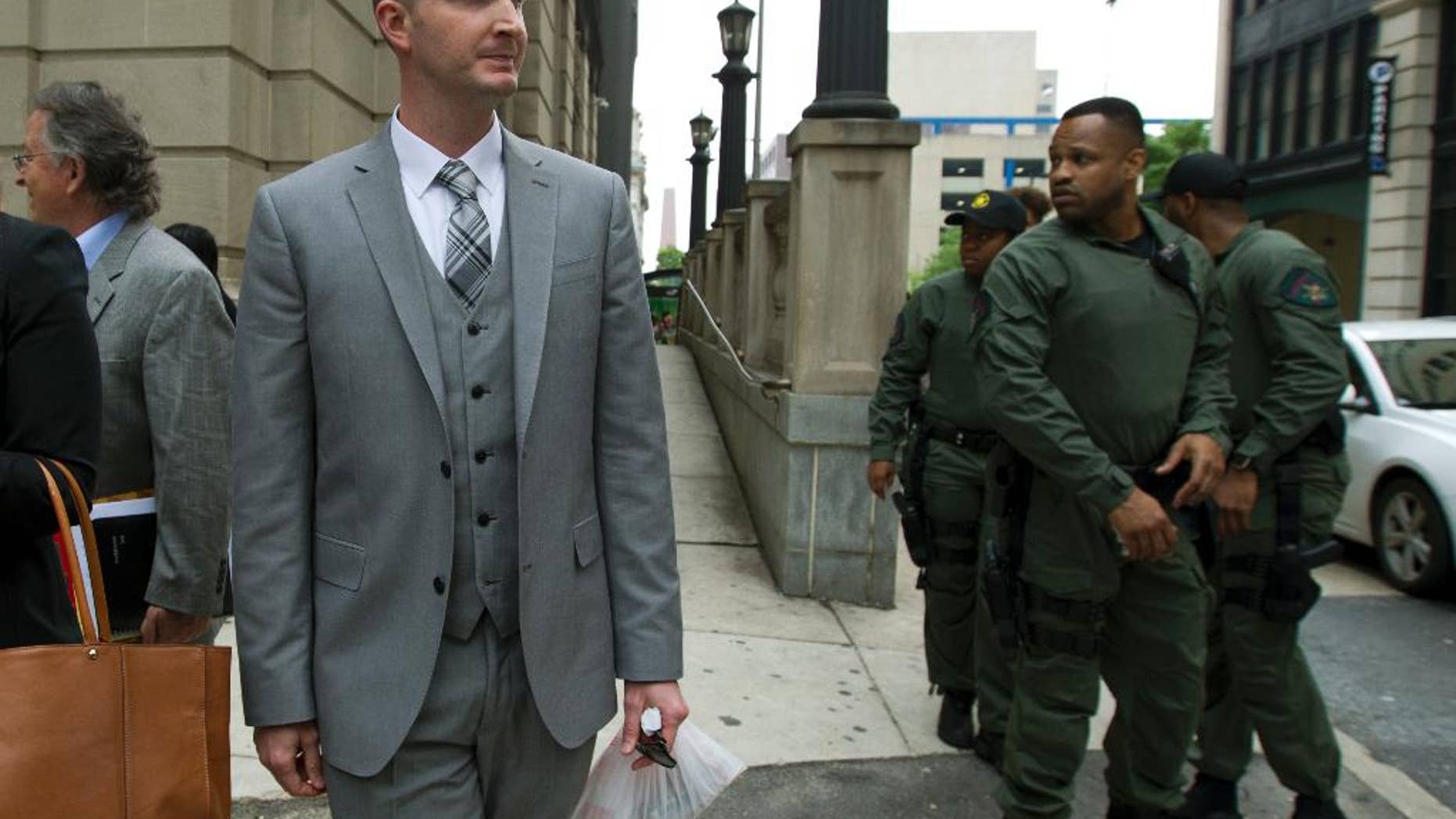 Officer Edward M. Nero one of six Baltimore city police officers charged in connection to the death of Freddie Gray, walks outside of the courthouse on a lunch break during the beginning of his trial, Thursday, May 12, 2016, in Baltimore. (AP Photo/Jose Luis Magana)