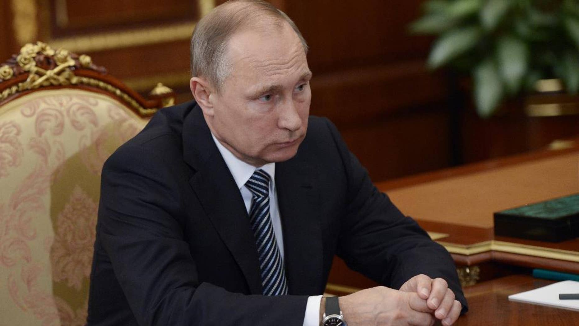 Russian President Vladimir Putin listens during a meeting with VTB CEP Andrei Kostin in Moscow's Kremlin on Tuesday, Sept. 27, 2016. The meeting focused on the current operations of the state-controlled VTB, Russia's second-largest bank. (Alexei Nikolsky/Sputnik, Kremlin Pool Photo via AP)