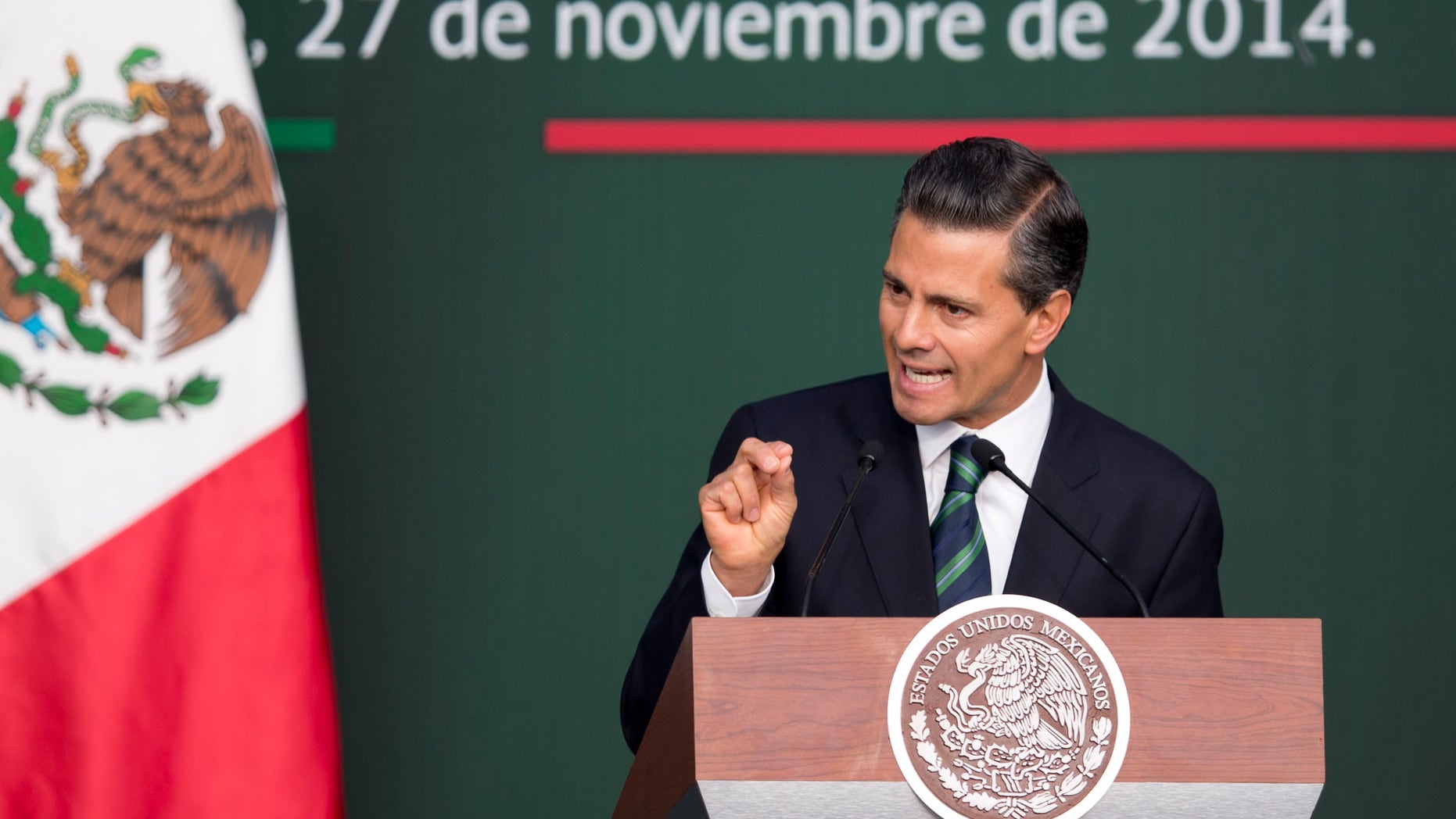Mexico's President Enrique Pena Nieto speaks during a ceremony at the National Palace in Mexico City, Thursday, Nov. 27, 2014. Mexico's president announced a new anti-crime plan that includes proposals for a nationwide ID, giving Congress the power to dissolve corrupt municipal government and fold their often-corrupt local police forces under the control of the countrys 31 state governments. The plan would also streamline the complex divisions between federal, state and local offenses. At present, some local police refuse to act to prevent federal crimes like drug trafficking. The plan would focus first on four of Mexicos most troubled states, Guerrero, Michoacan, Jalisco and Tamaulipas. It would also send more federal police and other forces to those states. (AP Photo/Eduardo Verdugo)