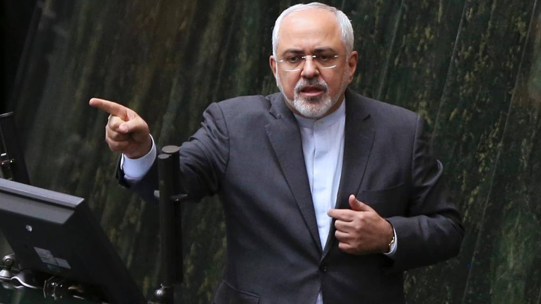 FILE - In this file photo dated Sunday, Oct. 2, 2016, Iranian Foreign Minister Mohammad Javad Zarif answers questions from lawmakers in an open session of parliament in Tehran, Iran, explaining the nuclear deal with world powers. Iran is to receive a huge shipment of natural uranium from Russia to compensate it for exporting tons of reactor coolant, according to unidentified Iranian diplomats Monday Jan. 9, 2017, in a move approved to keep Tehran committed to a landmark nuclear pact. (AP Photo/Vahid Salemi, FILE)