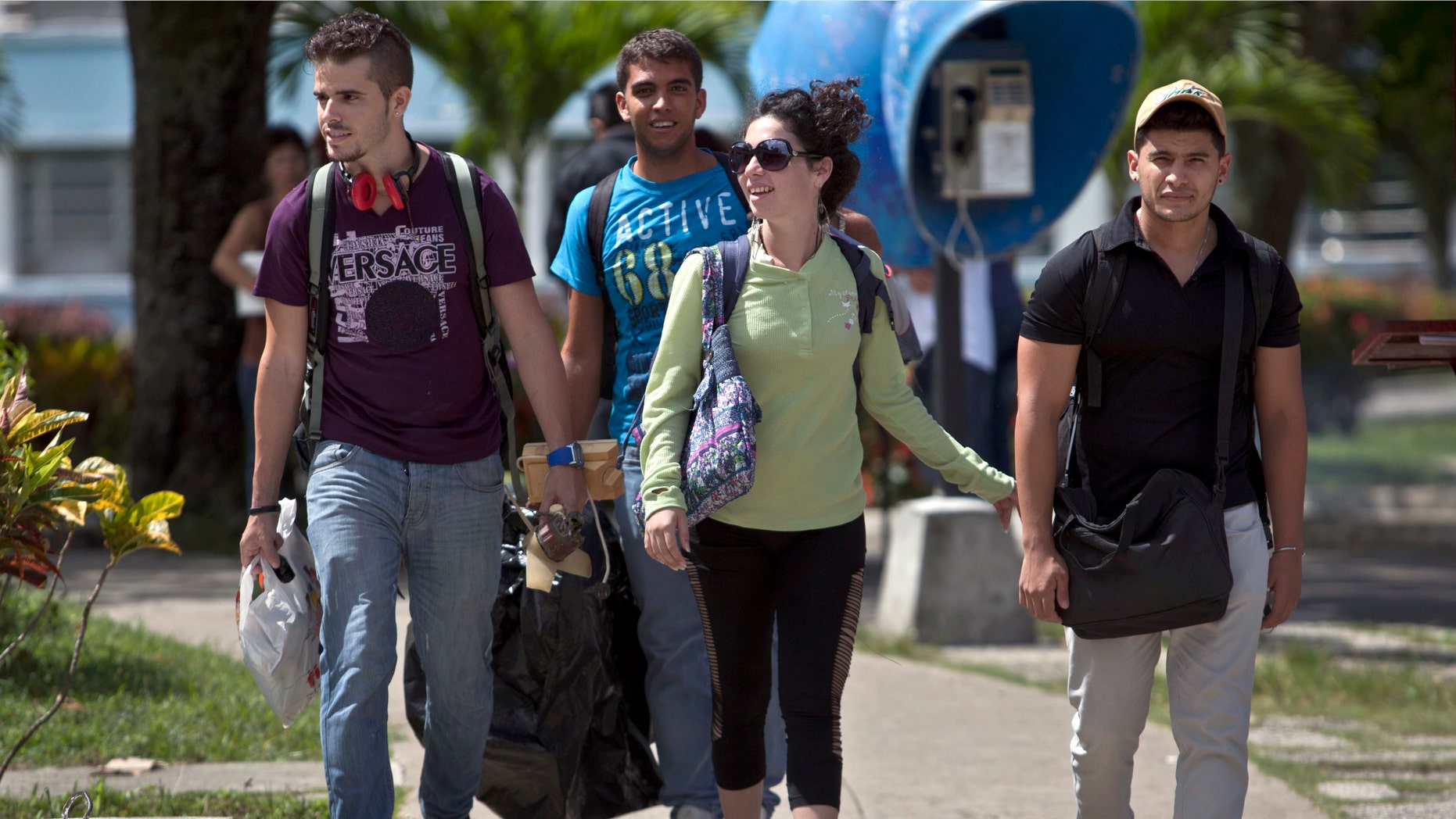 In this July 11, 2014, photo, Cuban students exit Marta Abreu Central University in Santa Clara, Cuba. Beginning as early as October 2009, a project overseen by the U.S. Agency for International Development sent Venezuelan, Costa Rican and Peruvian nationals to Cuba to cultivate a new generation of political activists. Often posing as tourists, the young travelers befriended Cuban students. Fernando Murillo, contracted to turn politically apathetic young Cubans into âchange agents,â headed to Santa Clara and connected with a cultural group that called itself âRevolution,â a modest outfit of street artists devoted to electronic music and video. (AP Photo/Franklin Reyes)